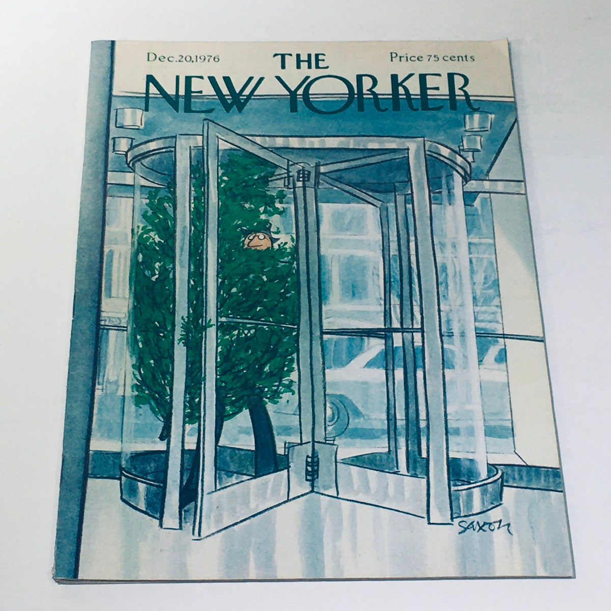 Cover of The New Yorker Magazine December 20 1976, featuring a whimsical illustration of a revolving door with greenery, designed by Charles Saxon.