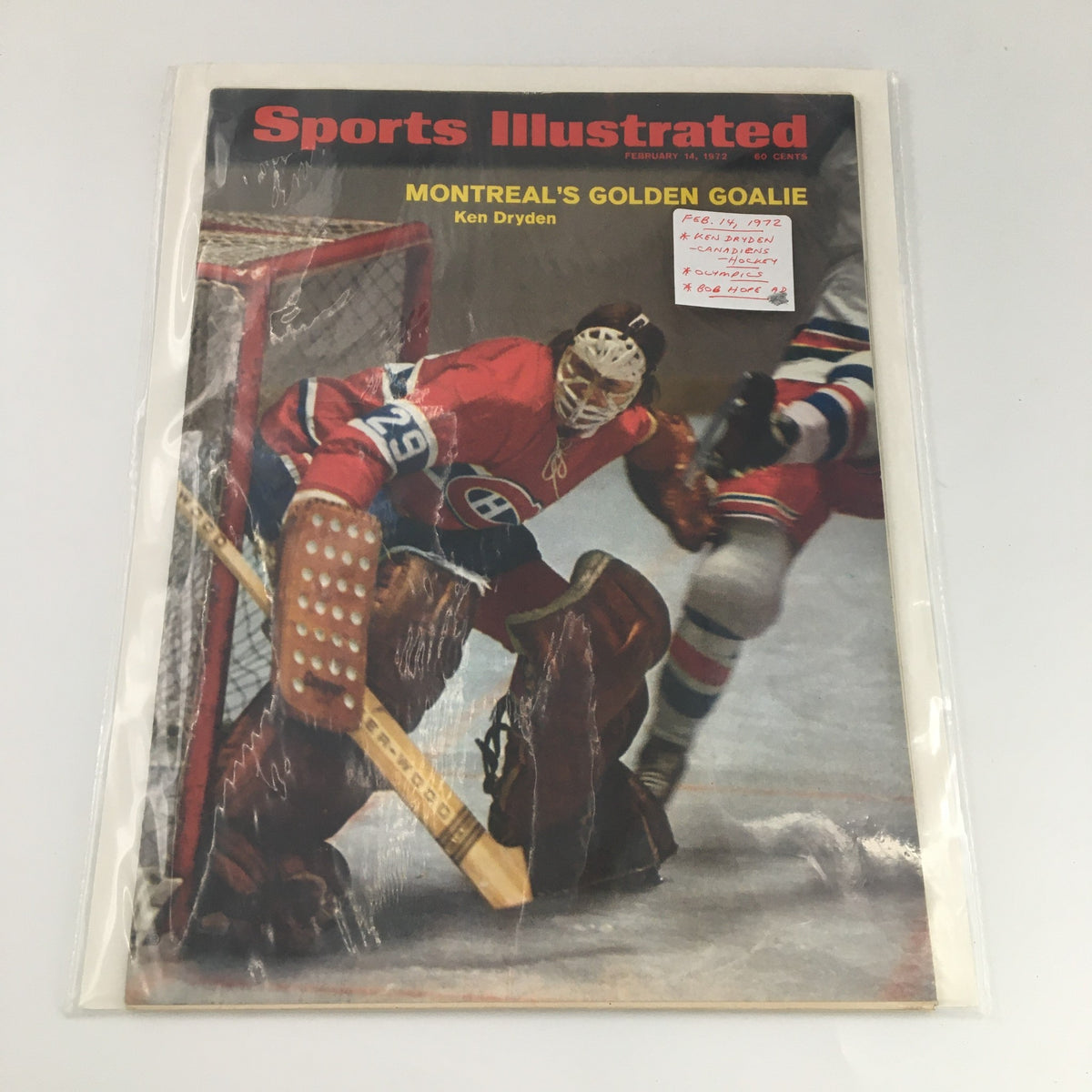 Sports Illustrated magazine from February 14, 1972, featuring Ken Dryden on the cover, encased in protective plastic, highlighting his role as Montreal's golden goalie.
