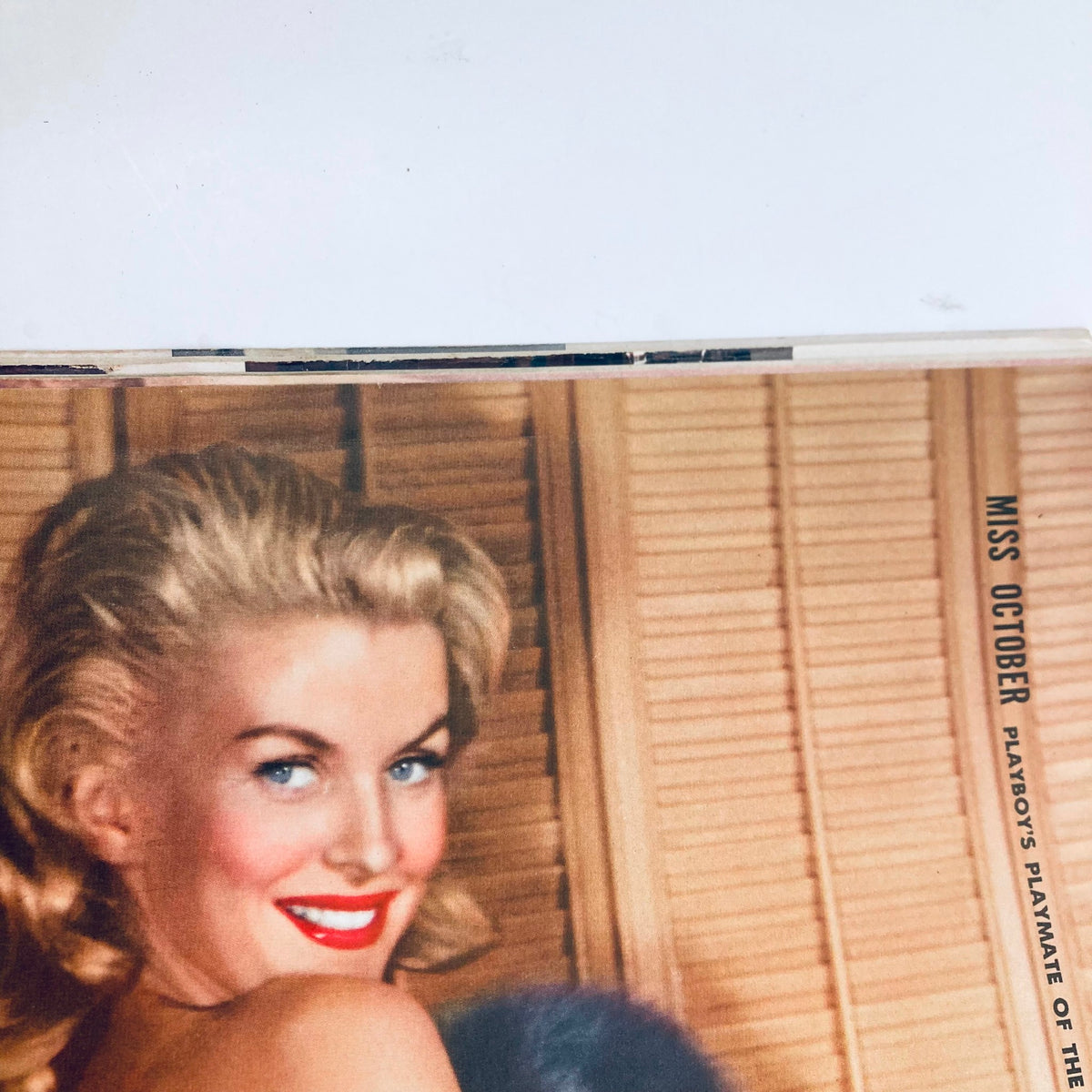 Close-up of the stunning cover of VTG Playboy Magazine October 1958 featuring a smiling model with blonde curls, showcasing the iconic allure of the era.