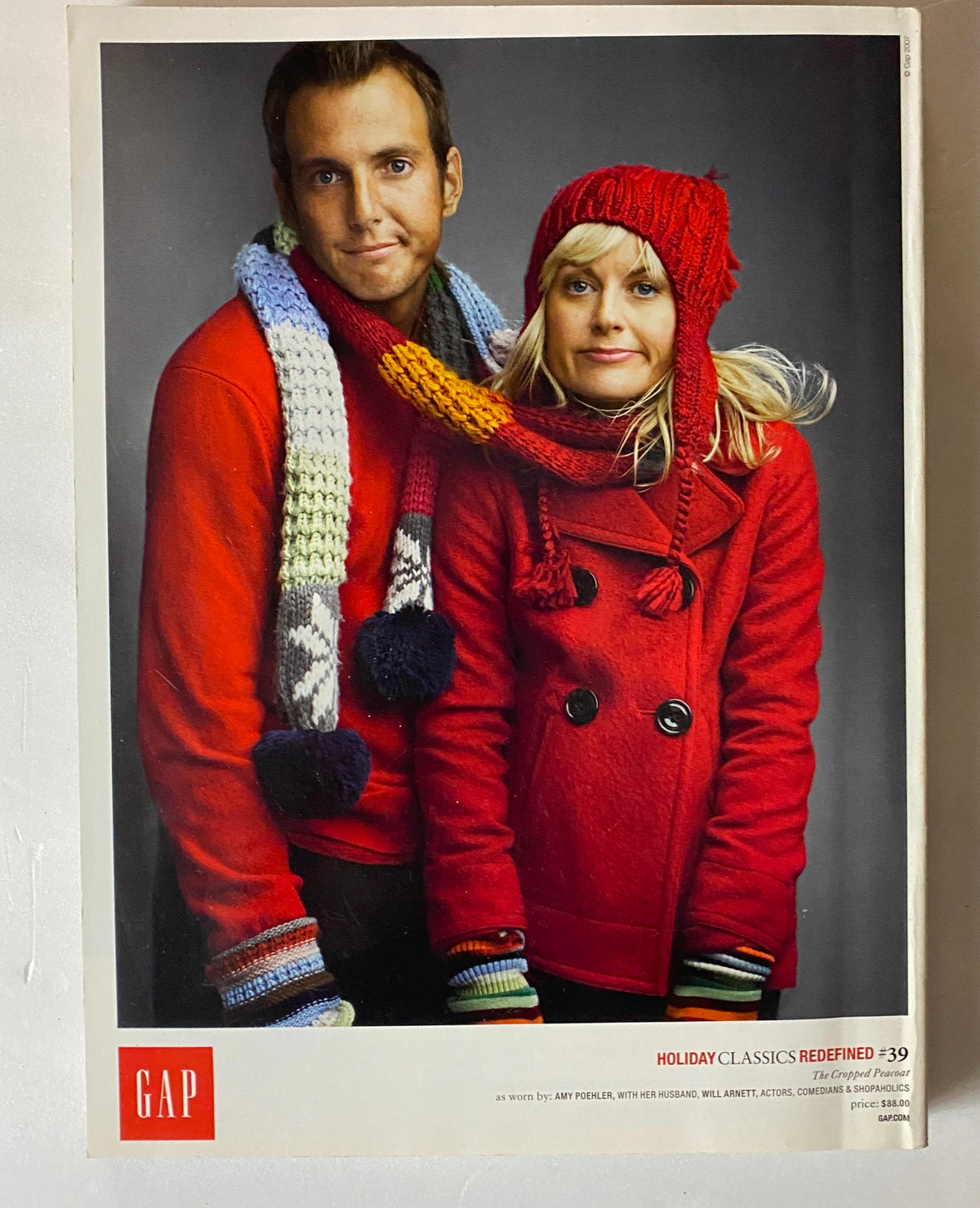 Holiday-themed advertisement from Vanity Fair Magazine December 2007 featuring a cheerful couple in winter attire, showcasing seasonal fashion trends.