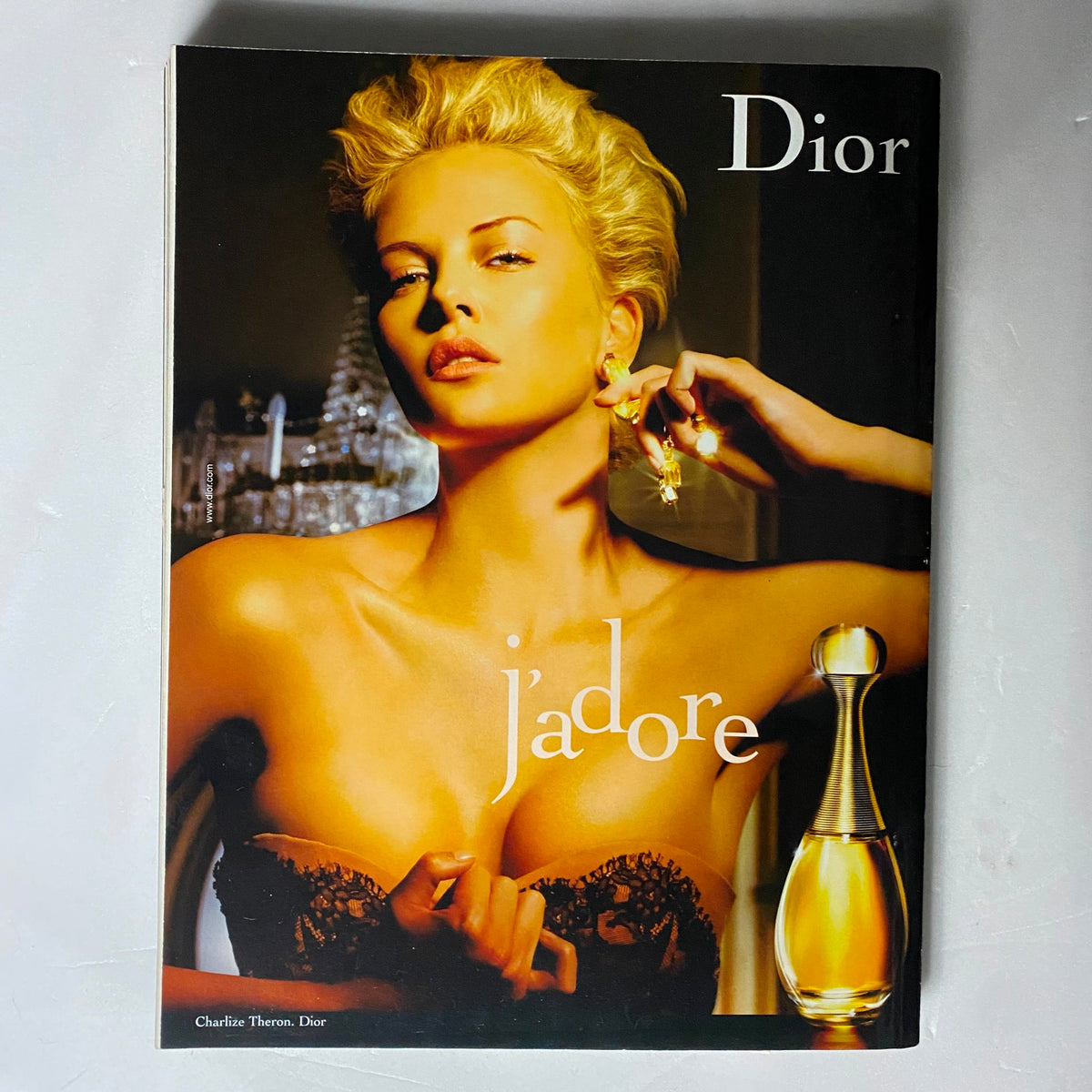 Cover of a Dior advertisement featuring Charlize Theron for J'adore perfume, included in Elle UK Magazine September 2006, illustrating luxury and beauty in fashion.