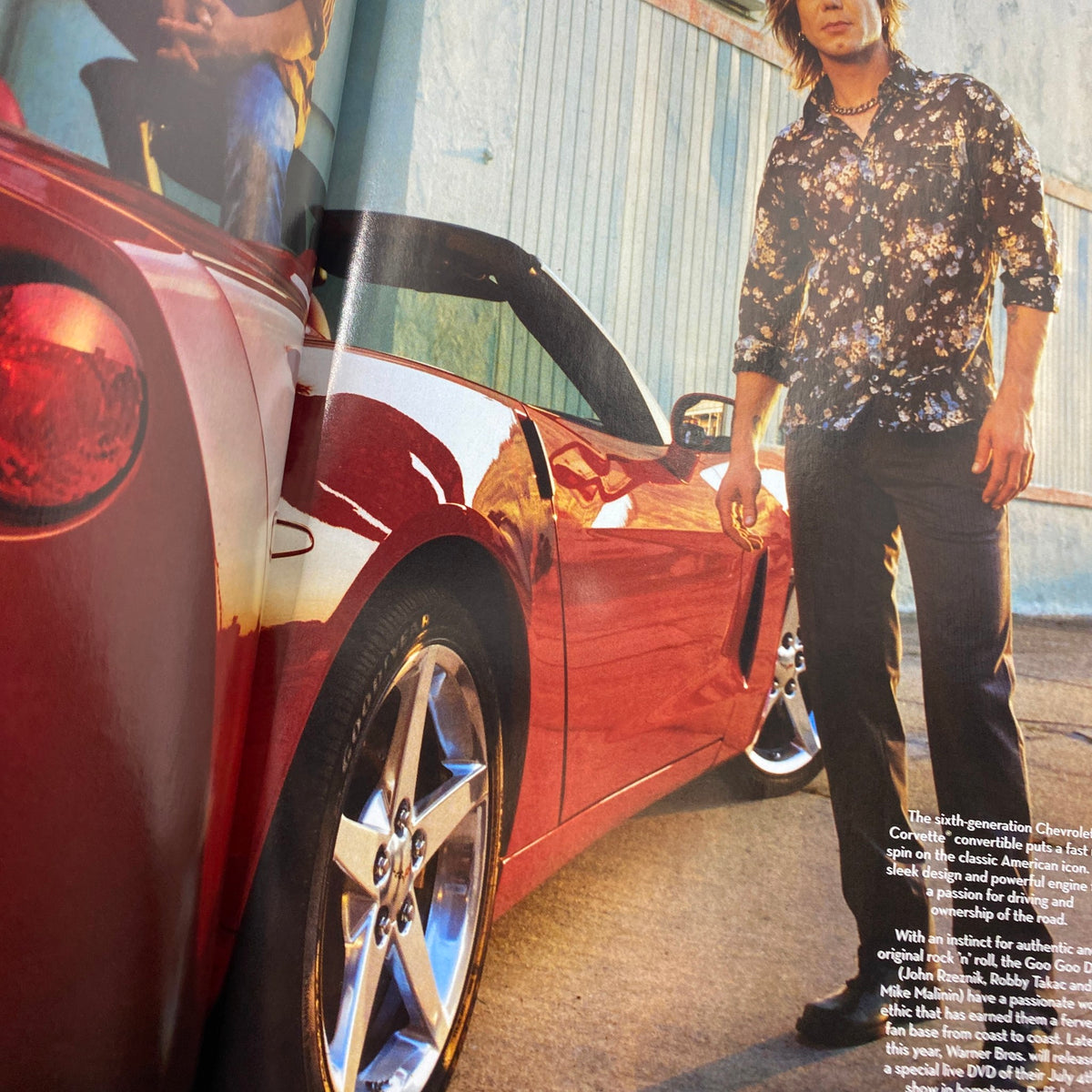 An artistic shot of a man next to a red convertible, included in the Fashion Rocks supplement to W Magazine, October 2004.