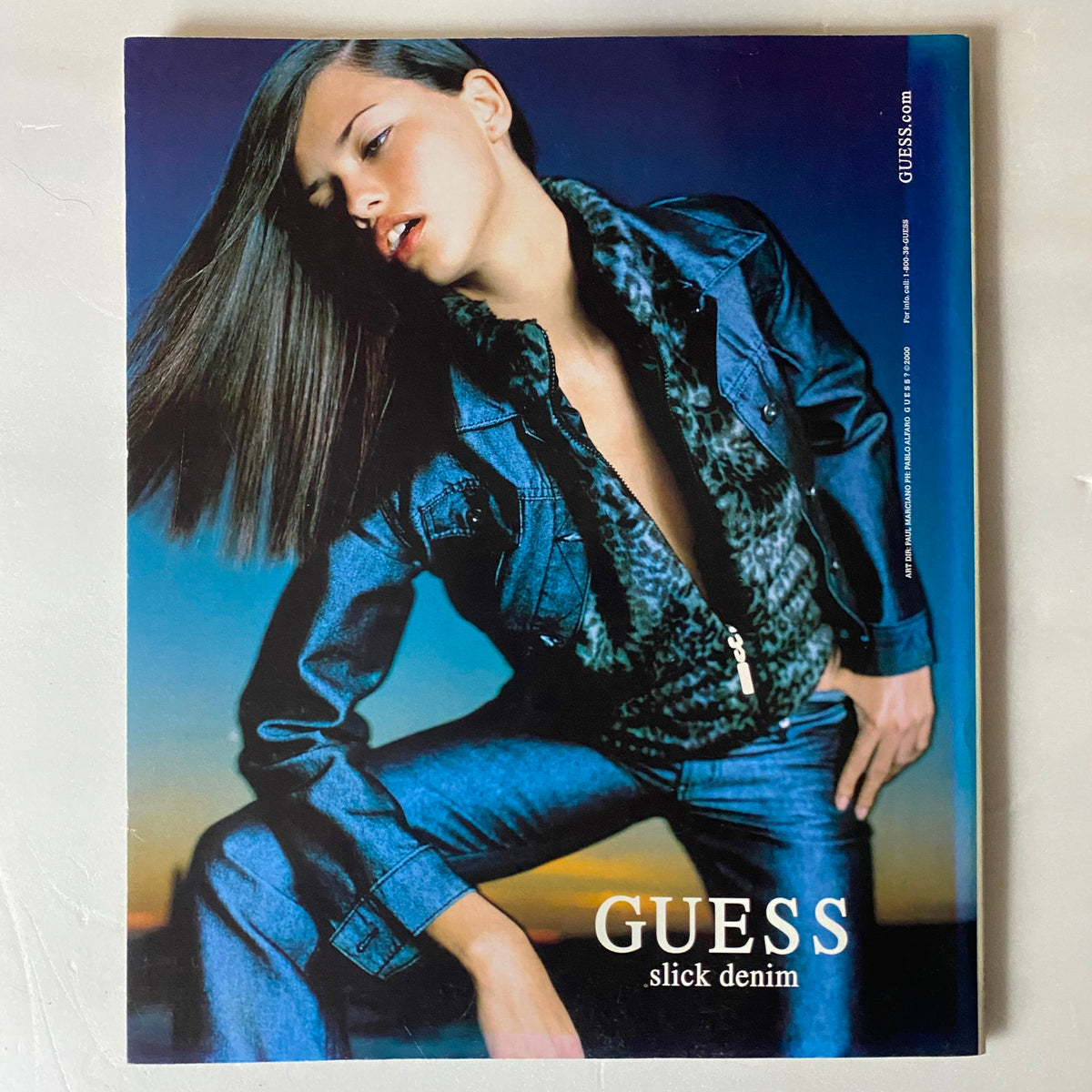 Advert for GUESS denim featuring a model in a stylish outfit, promoting the fashion aesthetic of the early 2000s, from City NY Magazine September - October 2000.