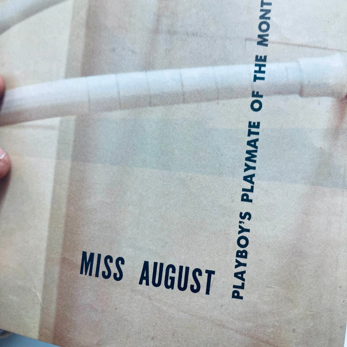Inside of VTG Playboy Magazine February 1957, highlighting the page that announces 'Miss August', which showcases the Playmate of the Month.
