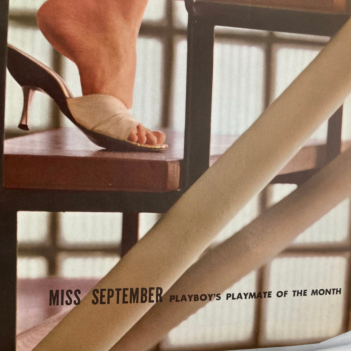 Close-up shot of the feet of Miss September, the Playmate of the Month in the Vintage Playboy Magazine September 1960, highlighting her high-heeled sandals.