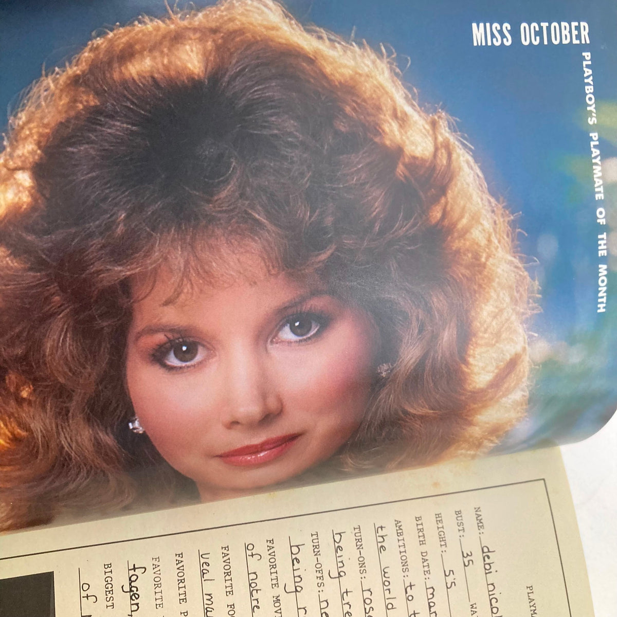 Inside page of Vintage Playboy Magazine October 1984 showcasing the Playmate of the Month, featuring a stunning portrait of a model and a detailed profile with personal information. A valuable collector's piece.
