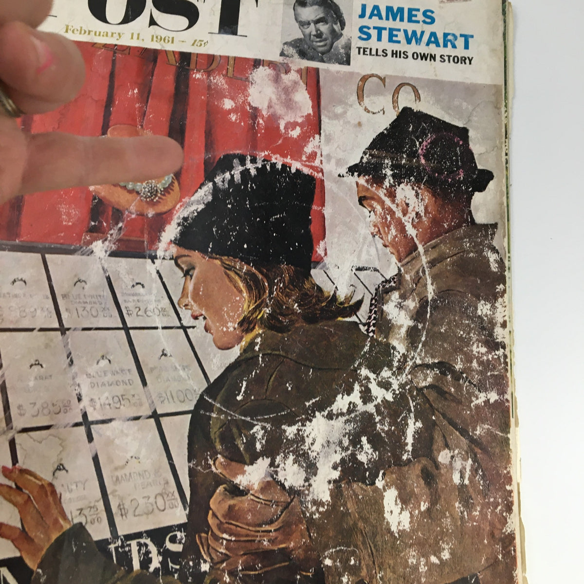 Close-up of The Saturday Evening Post cover from February 11, 1961, showcasing an illustration of a woman examining diamond prices while being accompanied by a man, highlighting the vintage art style.