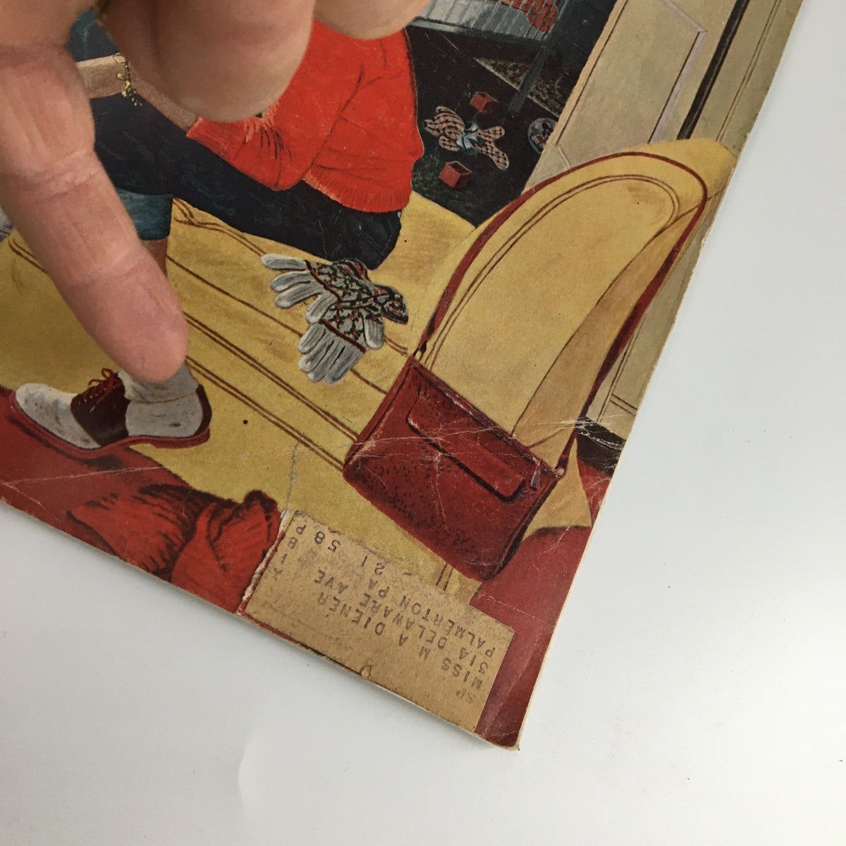Detail of The Saturday Evening Post cover dated January 4, 1958, highlighting the illustration and text related to Pablo Picasso, with a finger pointing at a feature of the magazine.