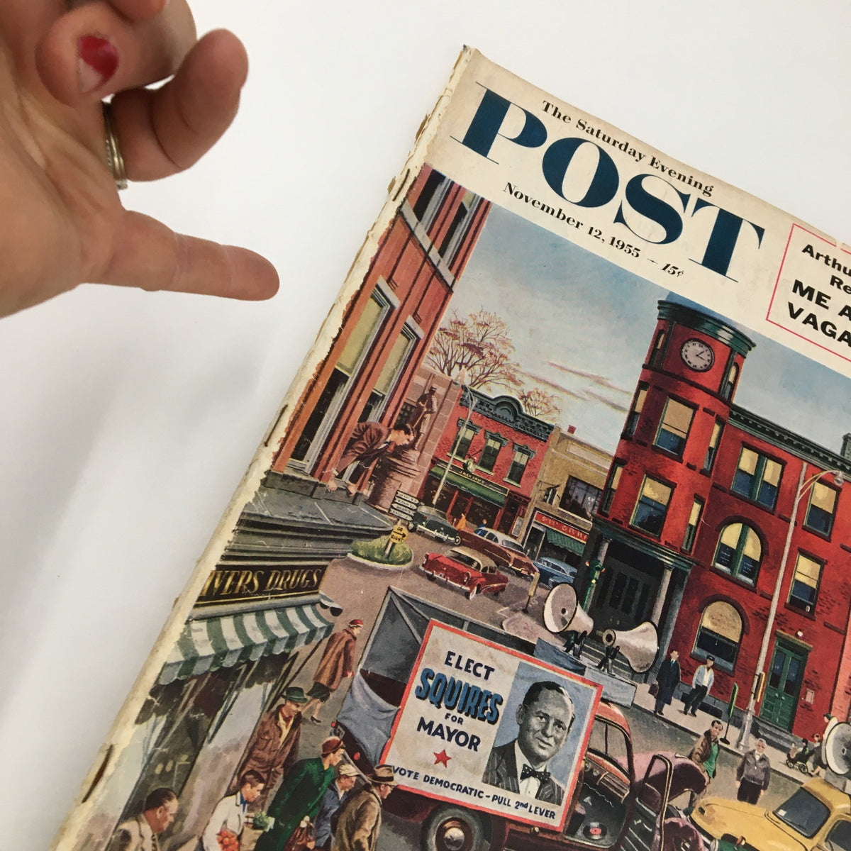 Close-up of The Saturday Evening Post November 12 1955 cover illustrating Arthur Godfrey's story 'Me and My Vagabond Youth', highlighting the vibrant artwork and details of a historical American street scene.