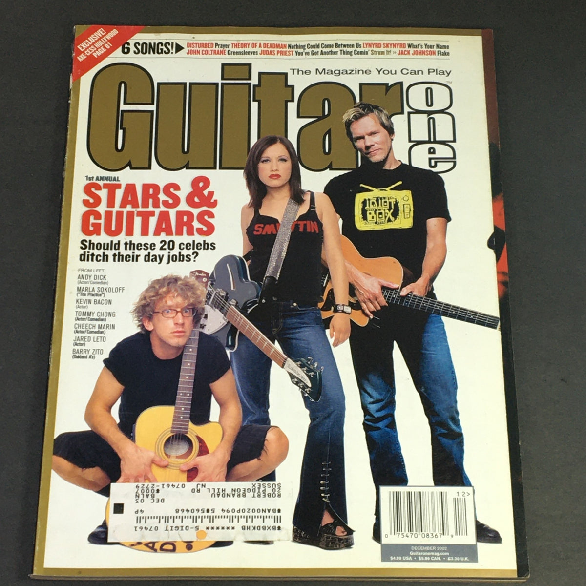 Guitar One Magazine December 2002 cover featuring Stars & Guitars, with celebrities Andy Dick, Marla Sokoloff, and an unnamed guitarist. This issue showcases iconic moments from early 2000s music culture.