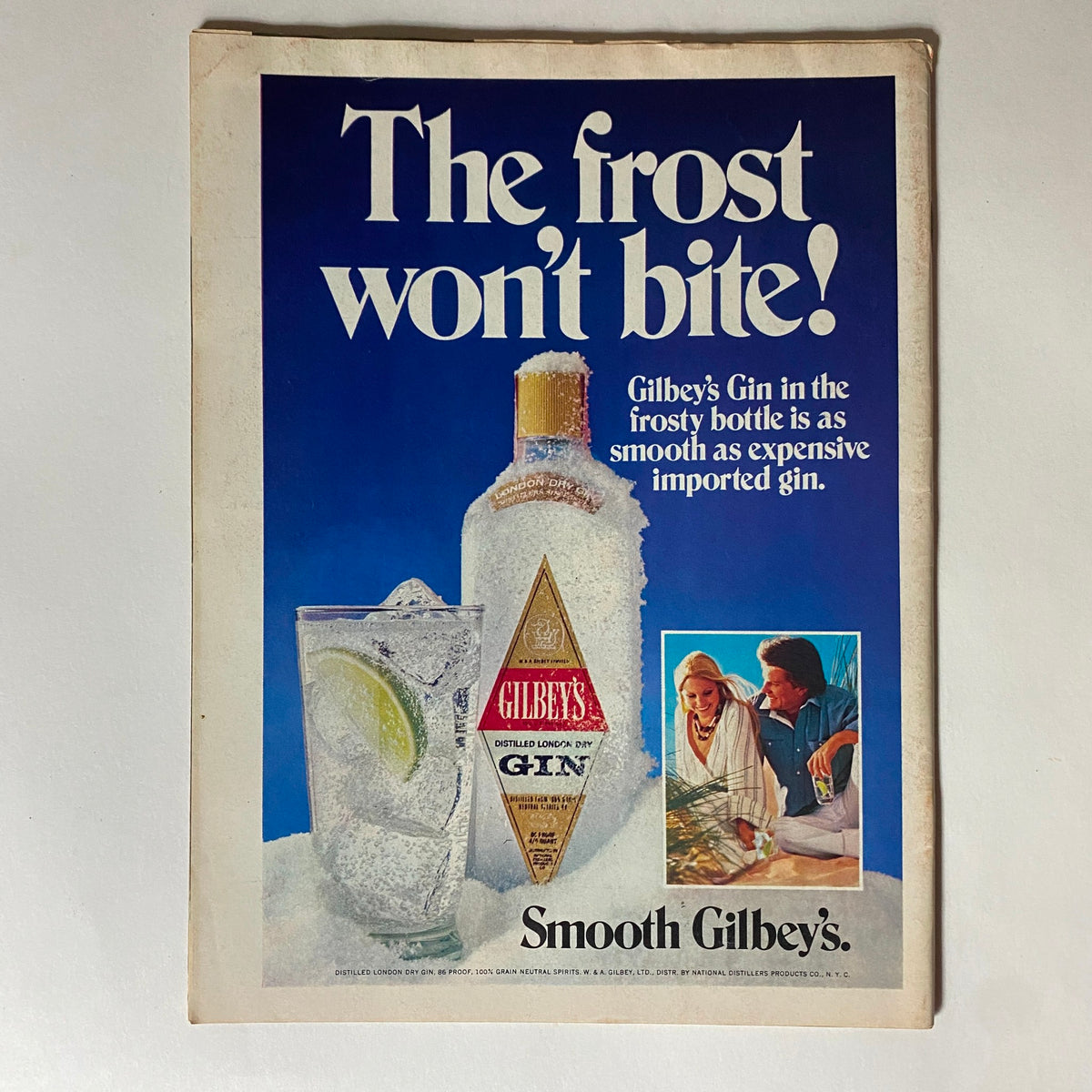 Advertisement for Gilbey's Gin from VTG Time Magazine August 2, 1976, showcasing the frosty bottle and promoting its smooth taste.