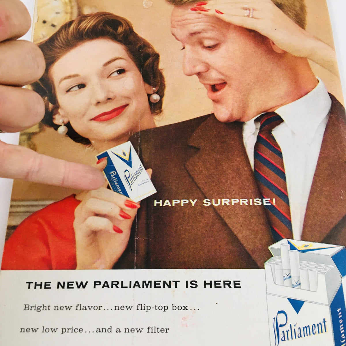 Vintage advertisement from The New Yorker Magazine, November 10, 1956, featuring a couple revealing the new Parliament cigarette product with cheerful expressions.
