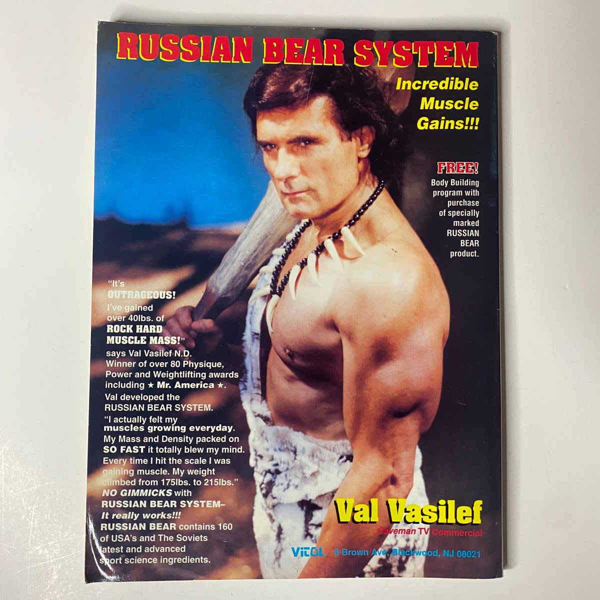 Cover of the Russian Bear System promotional material featuring Val Vasilev, showcasing bodybuilding techniques and fitness programs. Accompanying the Muscular Development Magazine April 1996 edition, it offers insights into muscle gains and training.