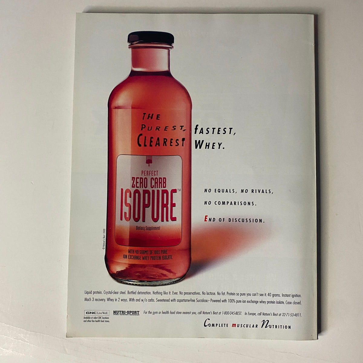Advertisement for Isopure protein supplement featuring a clear bottle design, showcasing the product's slogan "The Purest, Clearest, Fastest Whey" from Muscular Development Magazine March 2001 issue titled 'Big Guns'.