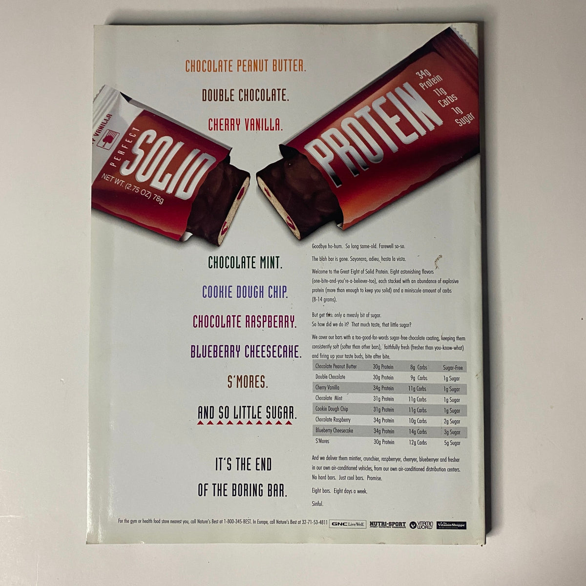 Back cover of Muscular Development Magazine July 2001 featuring various protein bar flavors including Chocolate Peanut Butter, Double Chocolate, Cherry Vanilla, and more. The design highlights the message 'It's the end of the boring bar,' promoting new and exciting protein bar options.