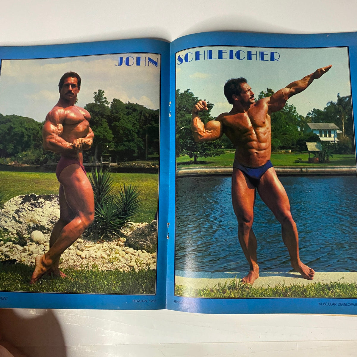 Muscular Development Magazine February 1983 featuring John Schleicher showcasing impressive bodybuilding poses by a scenic waterfront, highlighting muscle definition and strength.