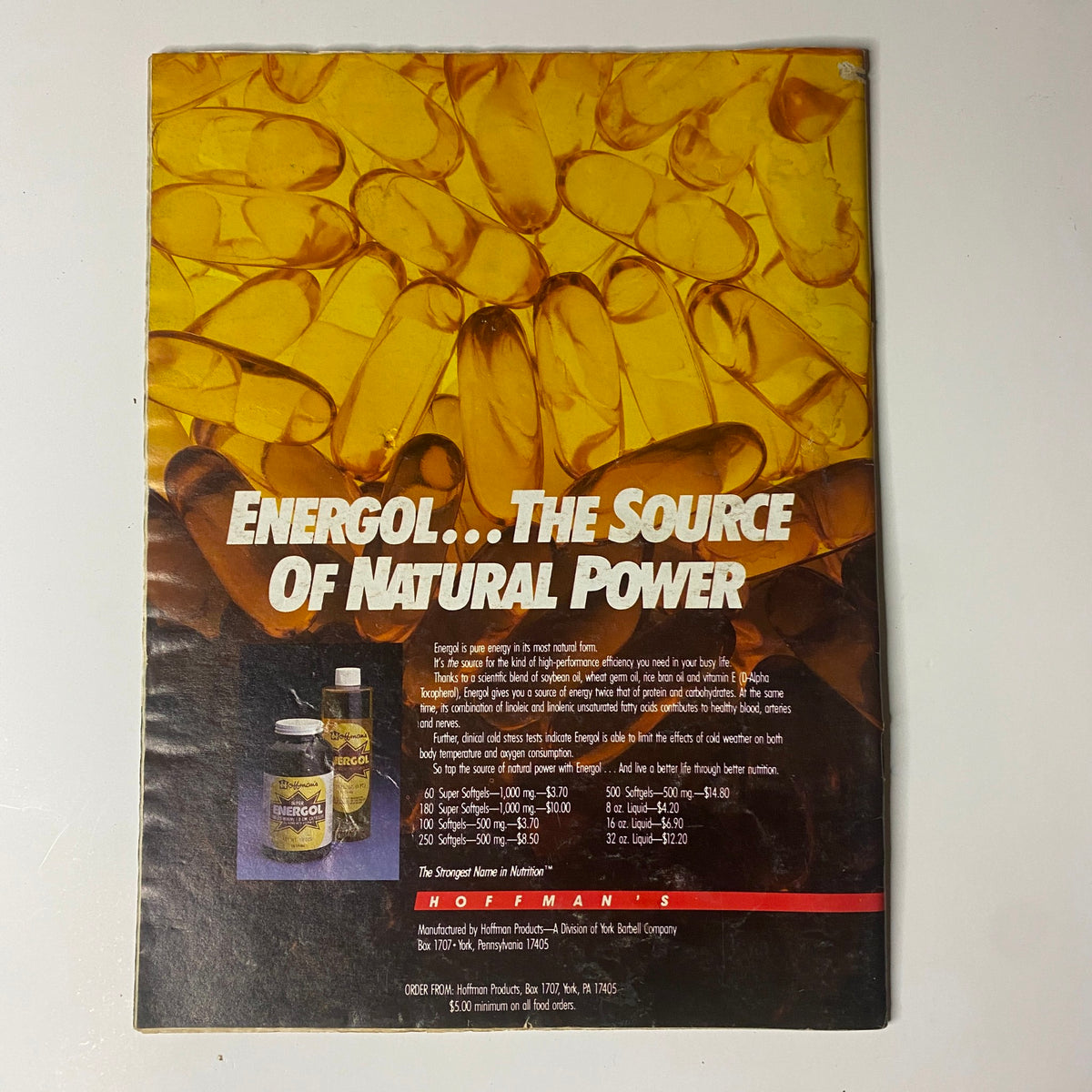 Back cover of Muscular Development Magazine November 1987 featuring an advertisement for Energol, promoting it as the source of natural power. The design includes golden capsules and emphasizes strength and nutrition.