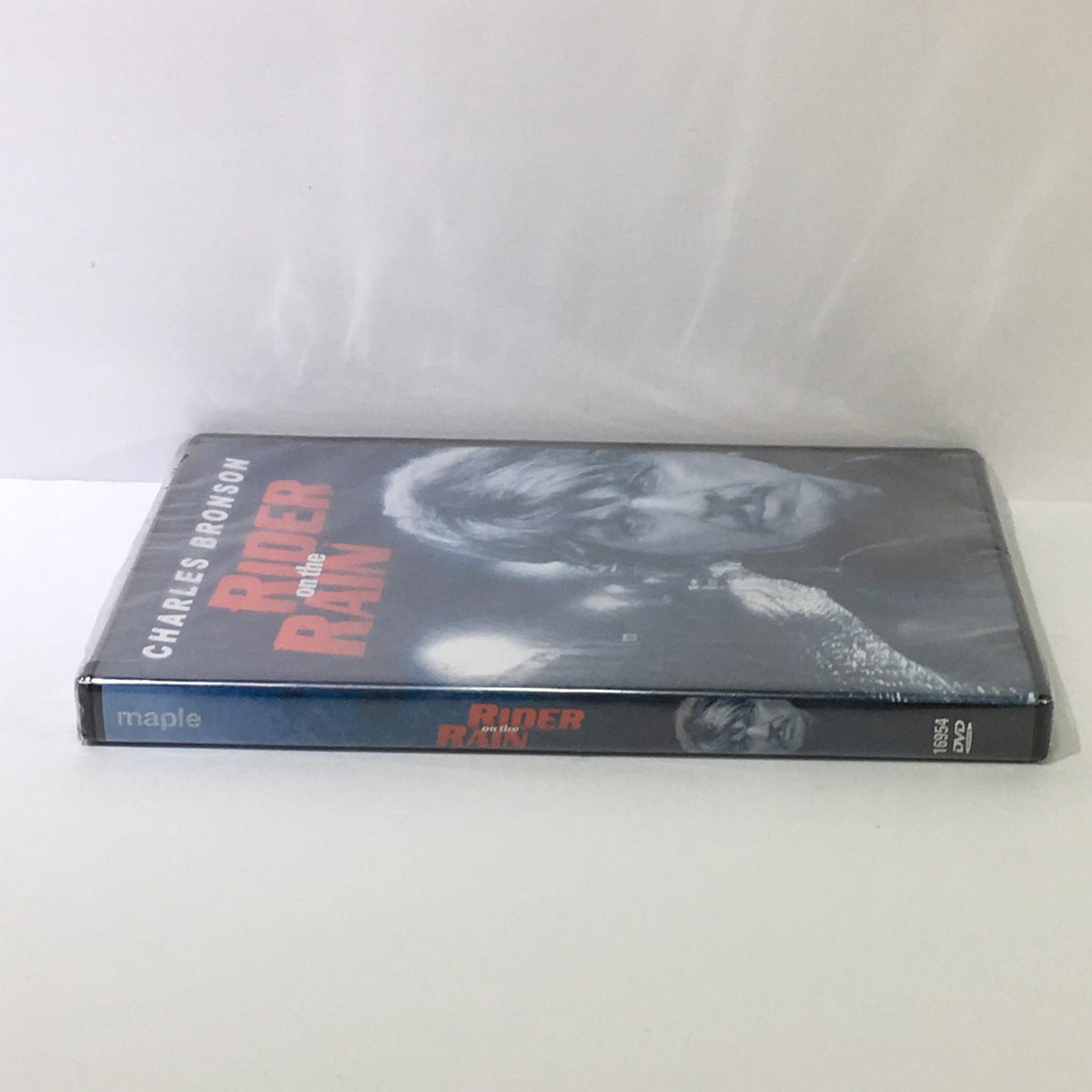 Side view of the DVD 'Rider on the Train Charles Bronson' showing the cover with bold title in red and blue packaging.