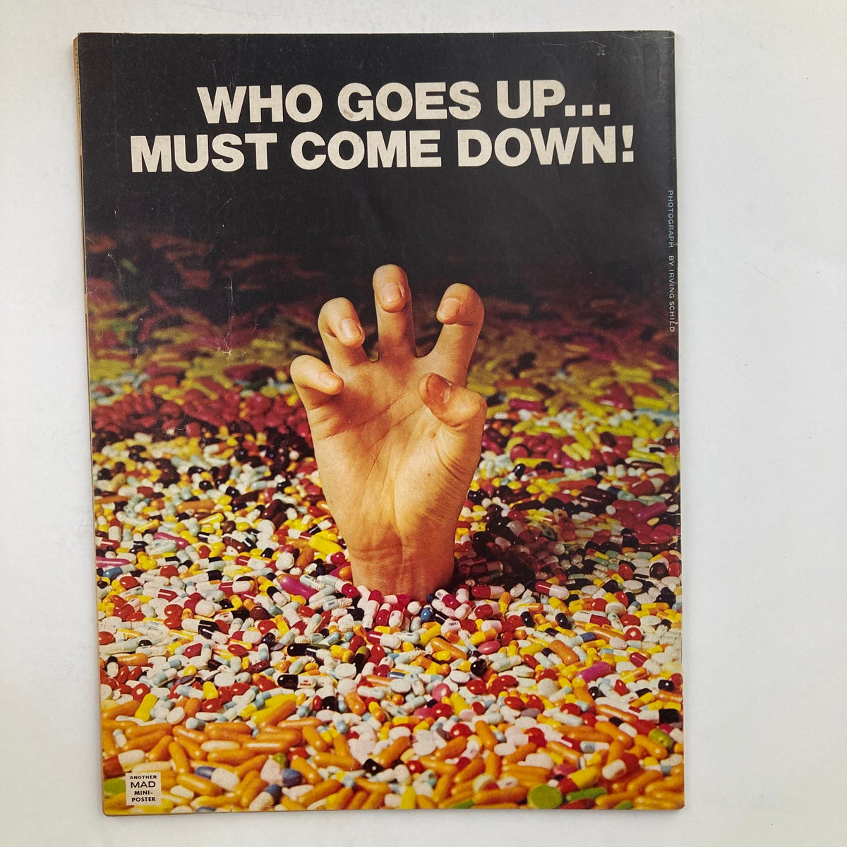 Cover of Mad Magazine March 1975 No. 173, showcasing a hand emerging from a candy-filled background with the caption 'Who Goes Up... Must Come Down!'