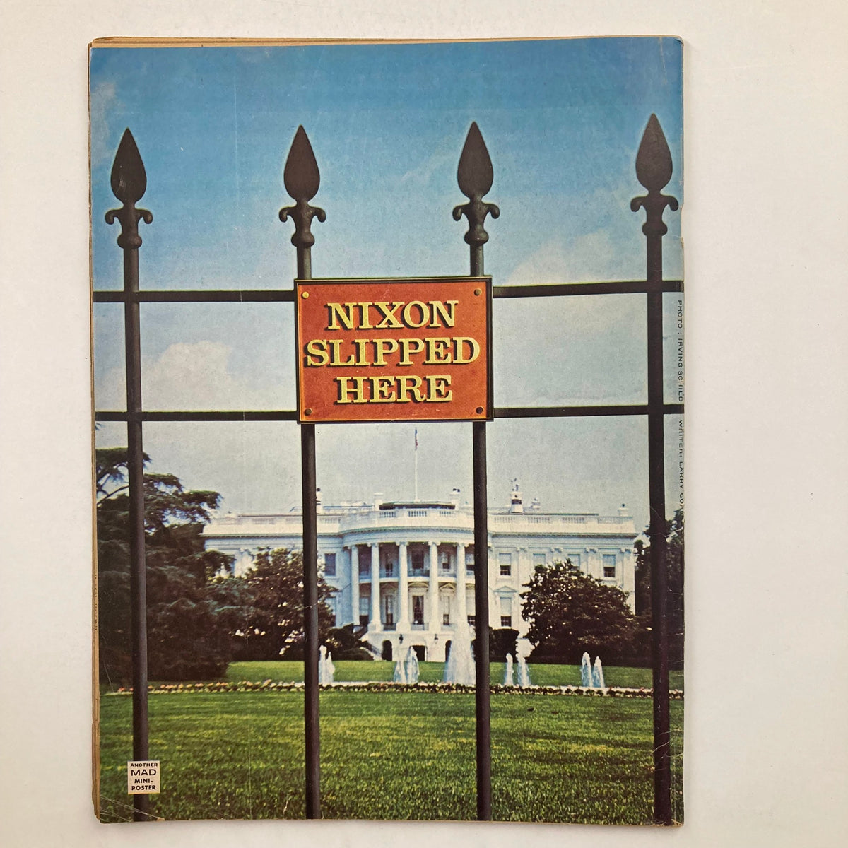 Back cover of Mad Magazine June 1974 No. 167, depicting a photograph of the White House with a sign reading 'NIXON SLIPPED HERE'.
