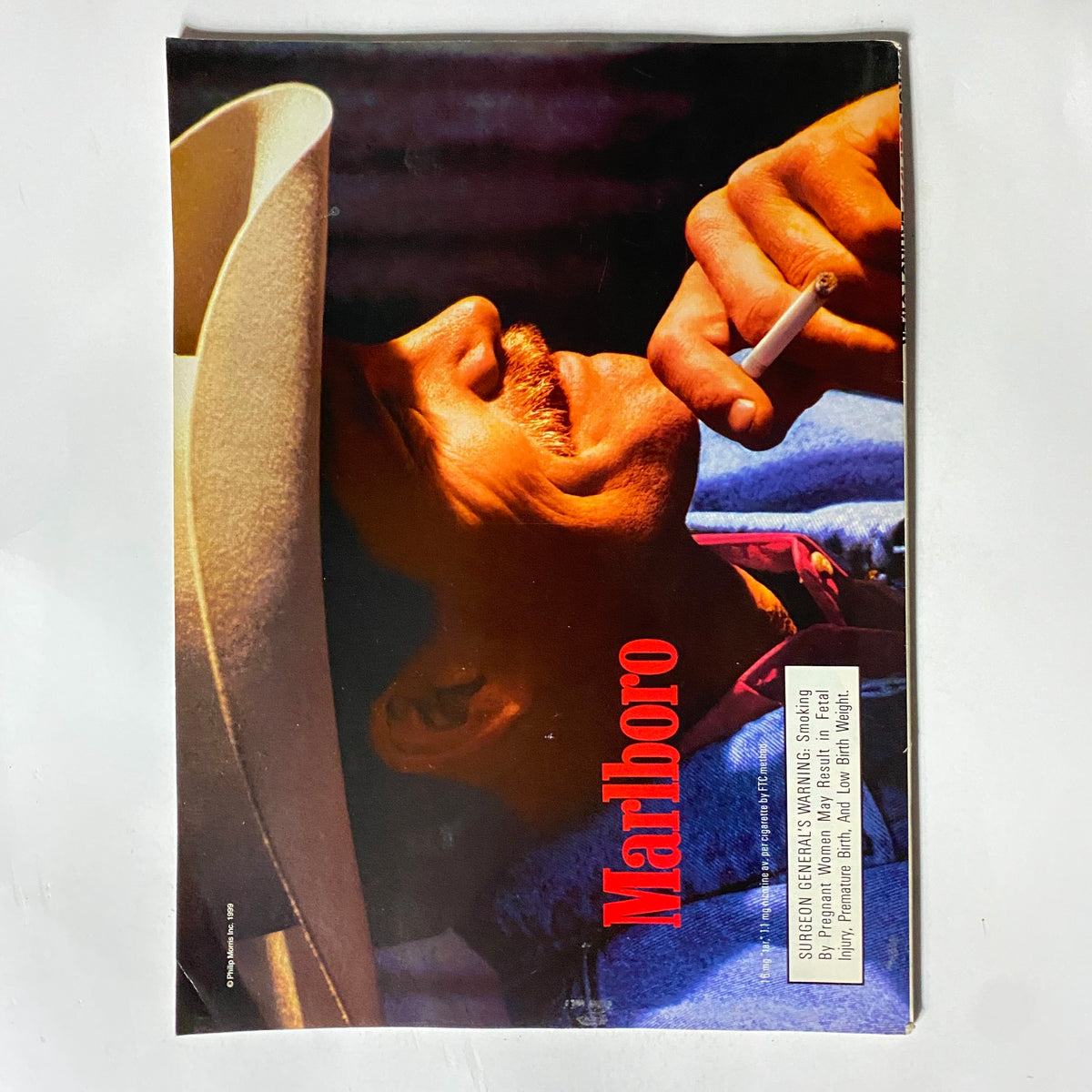 Cover of George Magazine July 1999 showcasing a charismatic man smoking, with the prominent Marlboro logo.