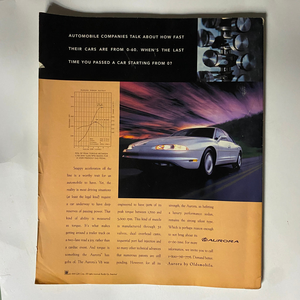 Back cover of George Magazine April - May 1996 featuring an advertisement for the Oldsmobile Aurora, highlighting car performance with a striking vehicle image.