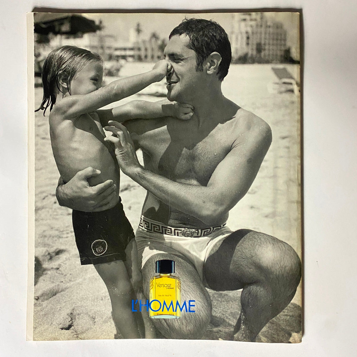 Black and white nostalgic image from George Magazine August 1996, representing family moments with an advertisement for Versace's L'Homme.