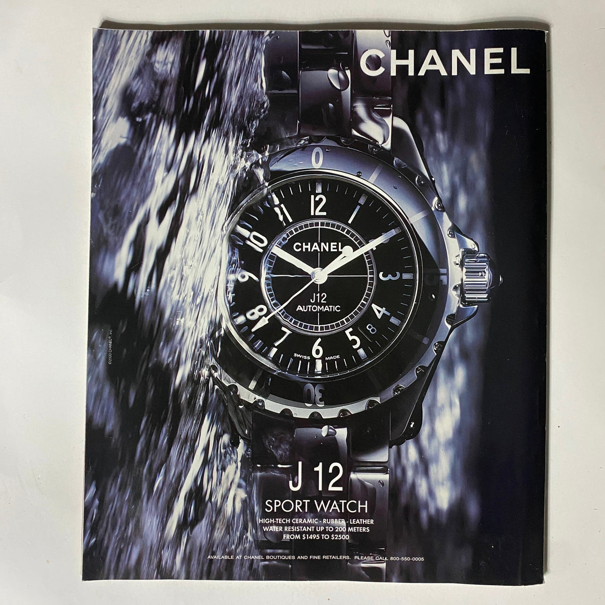 Chanel J12 Sport Watch advertisement featuring a high-quality image of the watch submerged in water, highlighting its design and features. George Magazine May 31, 2001 John F. Kennedy Jr. Farewell Issue.