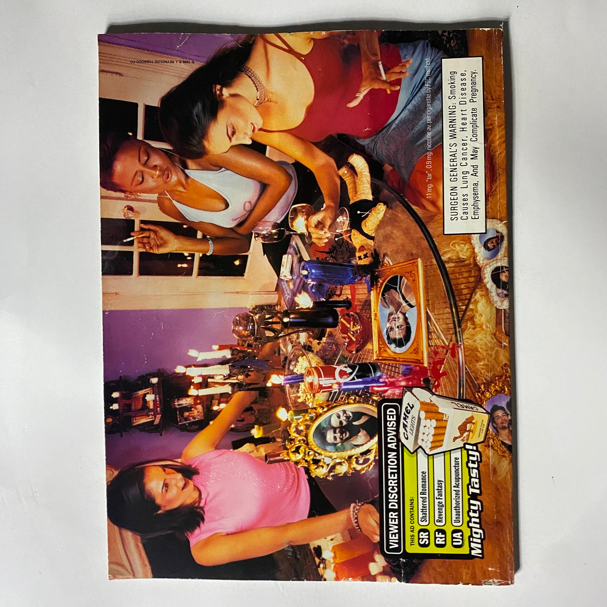 Cover of the September 1998 George Magazine with a striking image of two women at a table, highlighting the glamour and fashion focus of the magazine, featuring Karen Elson, Maggie Rizer, and Elsa Benitez.