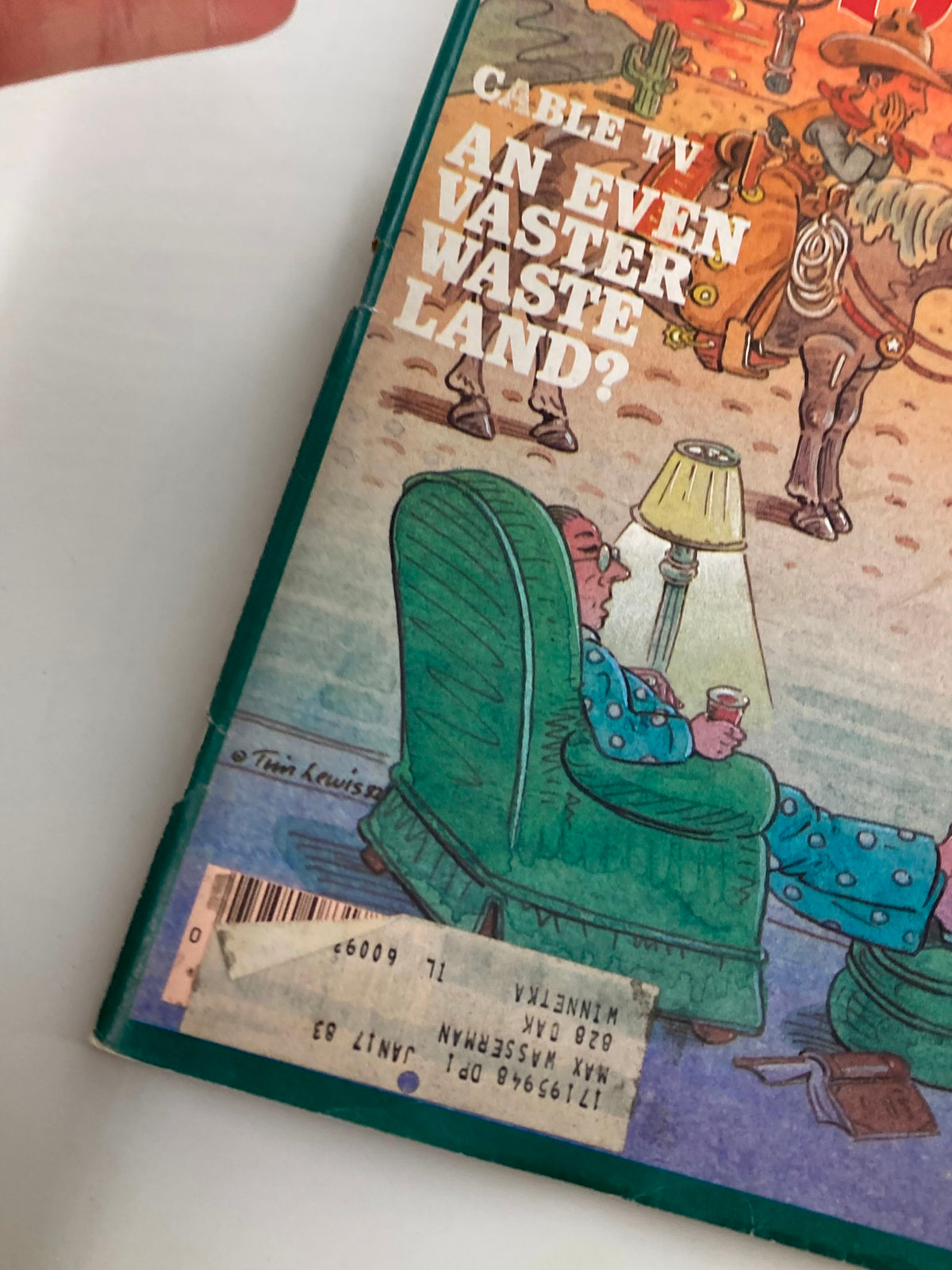 Close-up of the back cover of VTG Forbes Magazine May 24 1982 showcasing the title 'Cable TV: An Even Vaster Waste Land?' with an image of a relaxed viewer in a green chair.