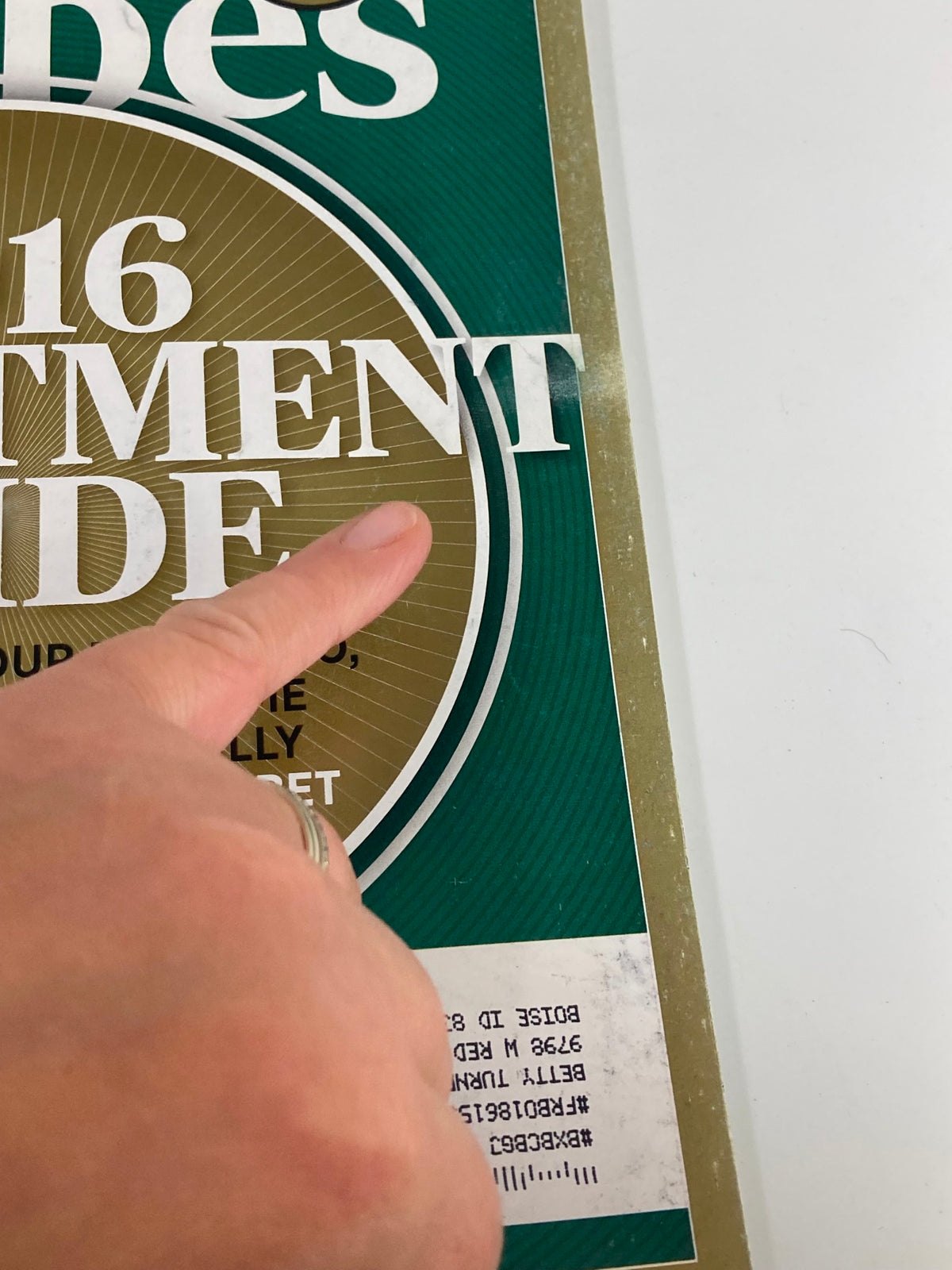 Close-up of the title '2016 Investment Guide' from the Forbes Magazine cover, showcasing tips to turbocharge portfolios and legally avoid taxes.