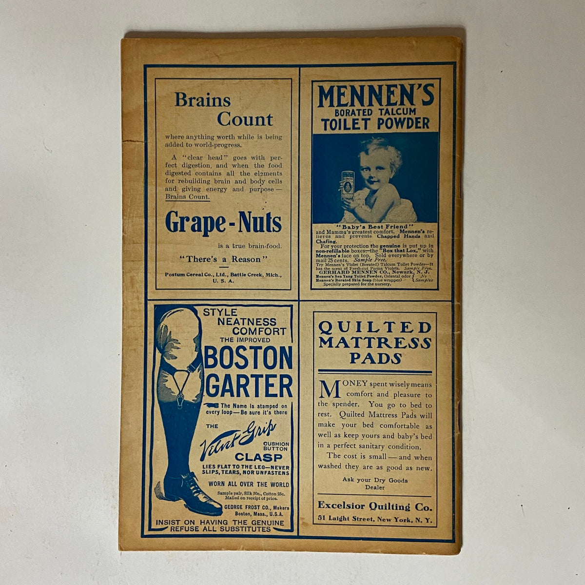 Vintage advertisement page from The Black Cat Magazine December 1908 featuring period ads, including Grape-Nuts, Boston Garter, and Menmen's Talcum Toilet Powder. A historic glimpse into early 20th-century marketing.