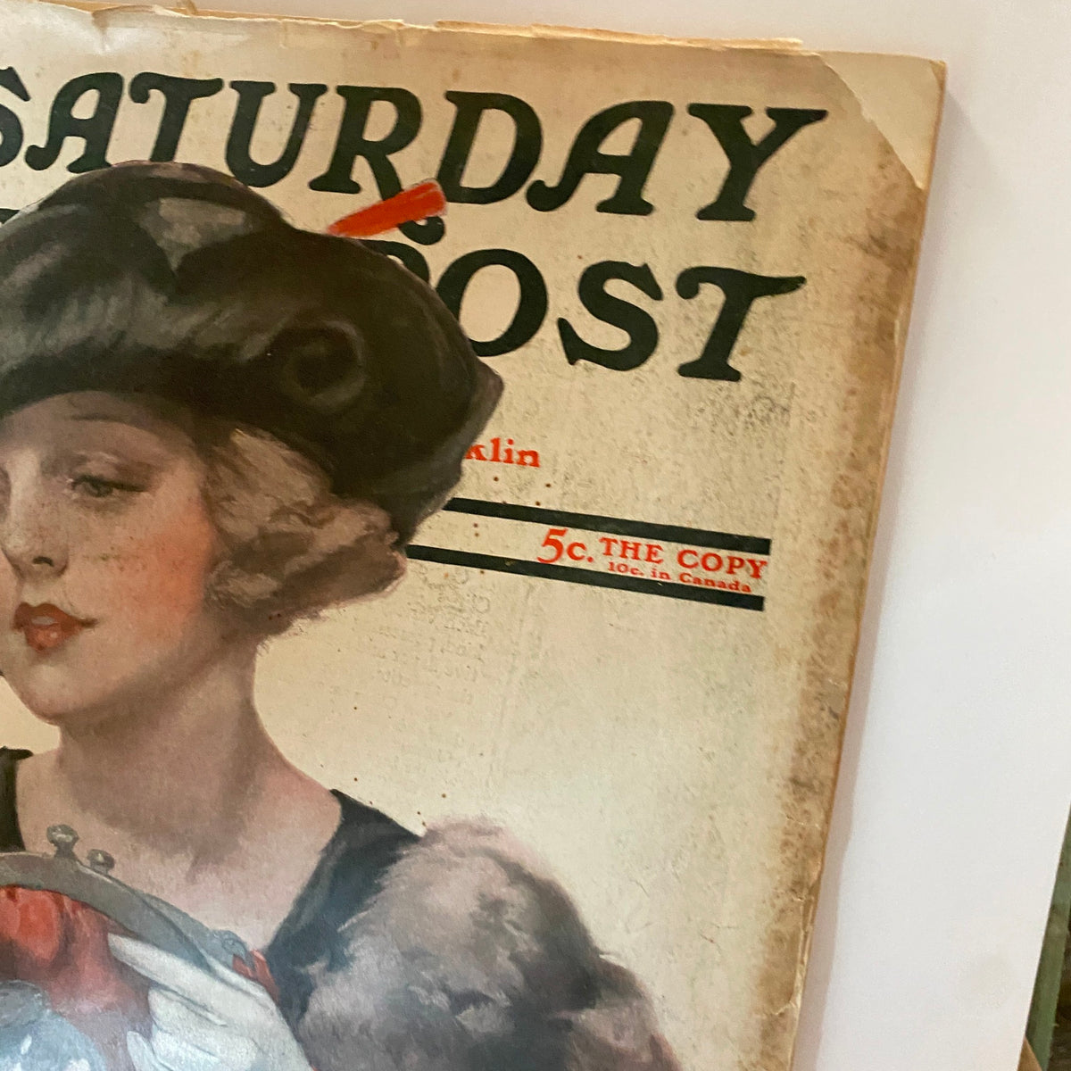 Close-up of the cover of The Saturday Evening Post, November 12, 1921, showcasing the woman in a hat and detailed attire, emphasizing the magazine's historical significance and artistic quality.