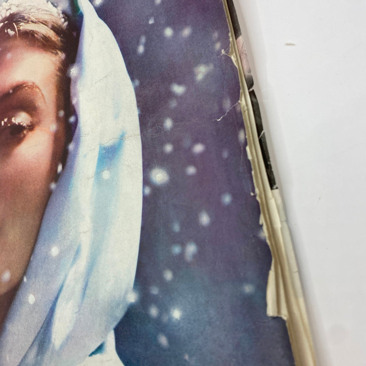 Close-up of the Ladies' Home Journal Magazine March 1940 cover featuring a woman in white, capturing details of vintage design and cover wear.