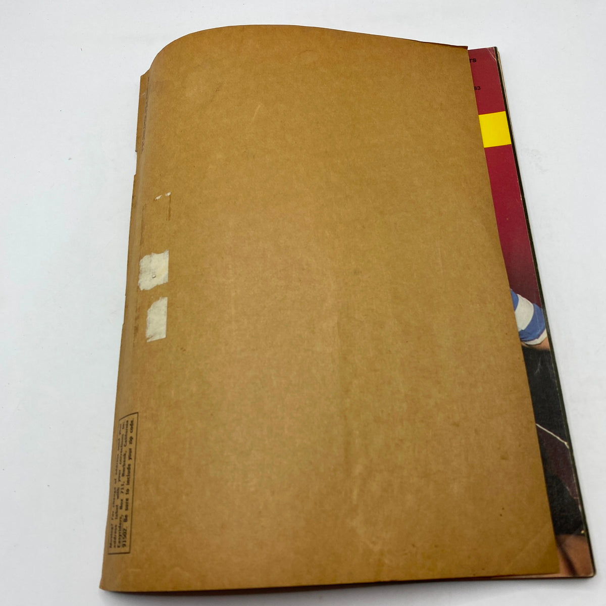 Back cover of VTG Easyriders Magazine April 1983 displaying a plain brown paper covering with some tape markings.