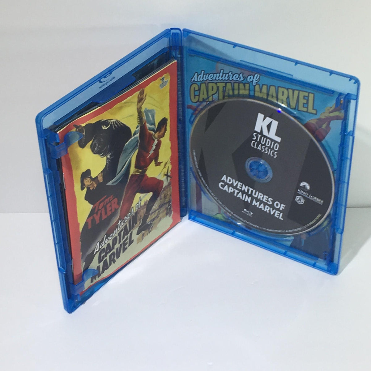 Inside view of the Adventures of Captain Marvel Blu-Ray case with the disc and booklet, highlighting vintage film content.
