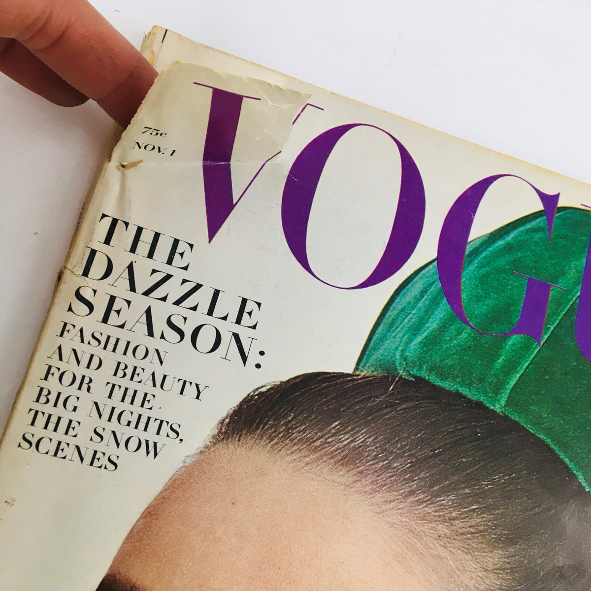 Close-up of the Vogue Magazine November 1 1964 cover featuring the title and a bright green hat, highlighting the fashion era of Audrey Hepburn and Givenchy.