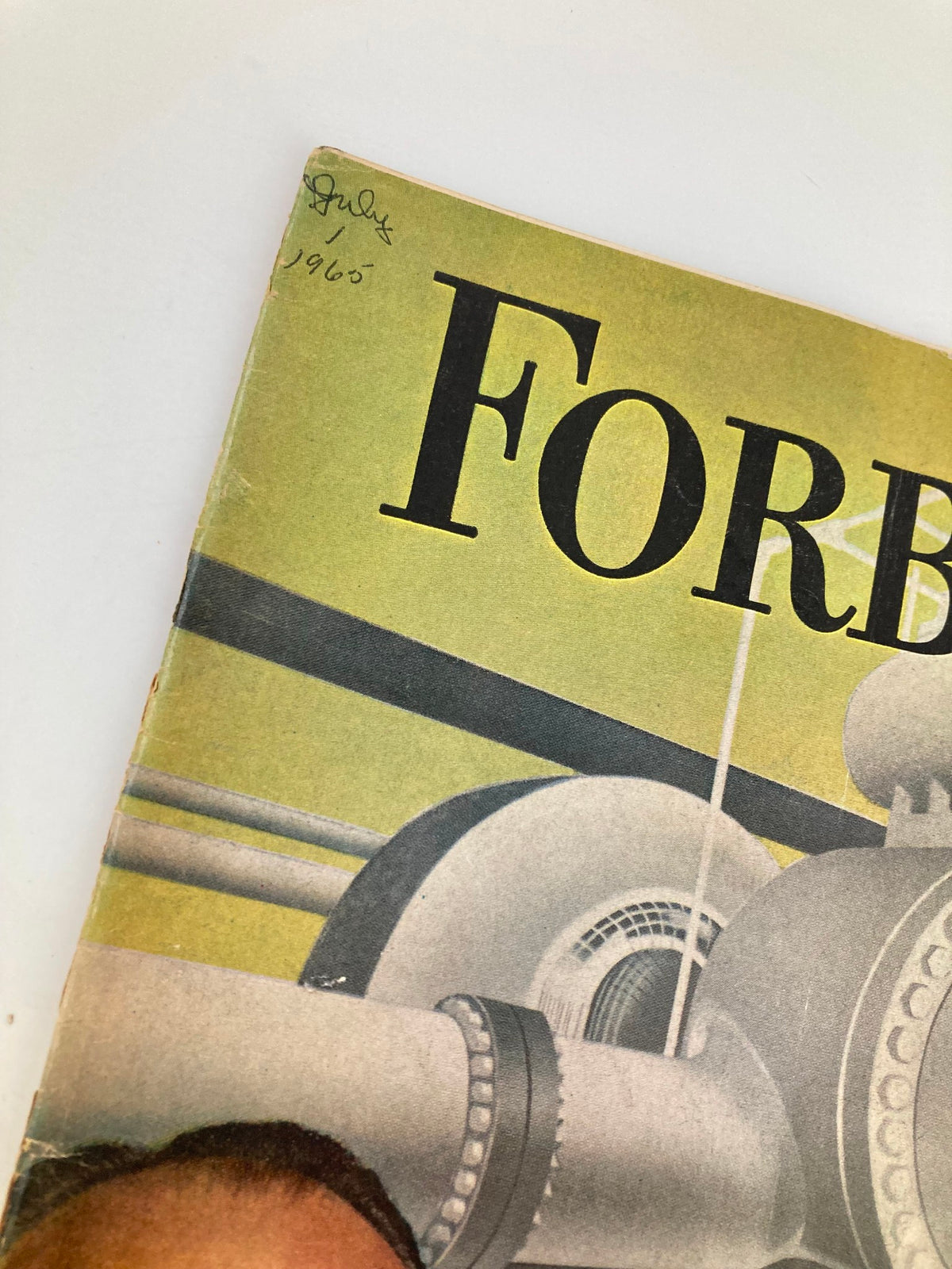 Close-up view of the upper section of the cover of VTG Forbes Magazine July 1, 1985 showing the magazine title and date, with a handwritten note from 1965.