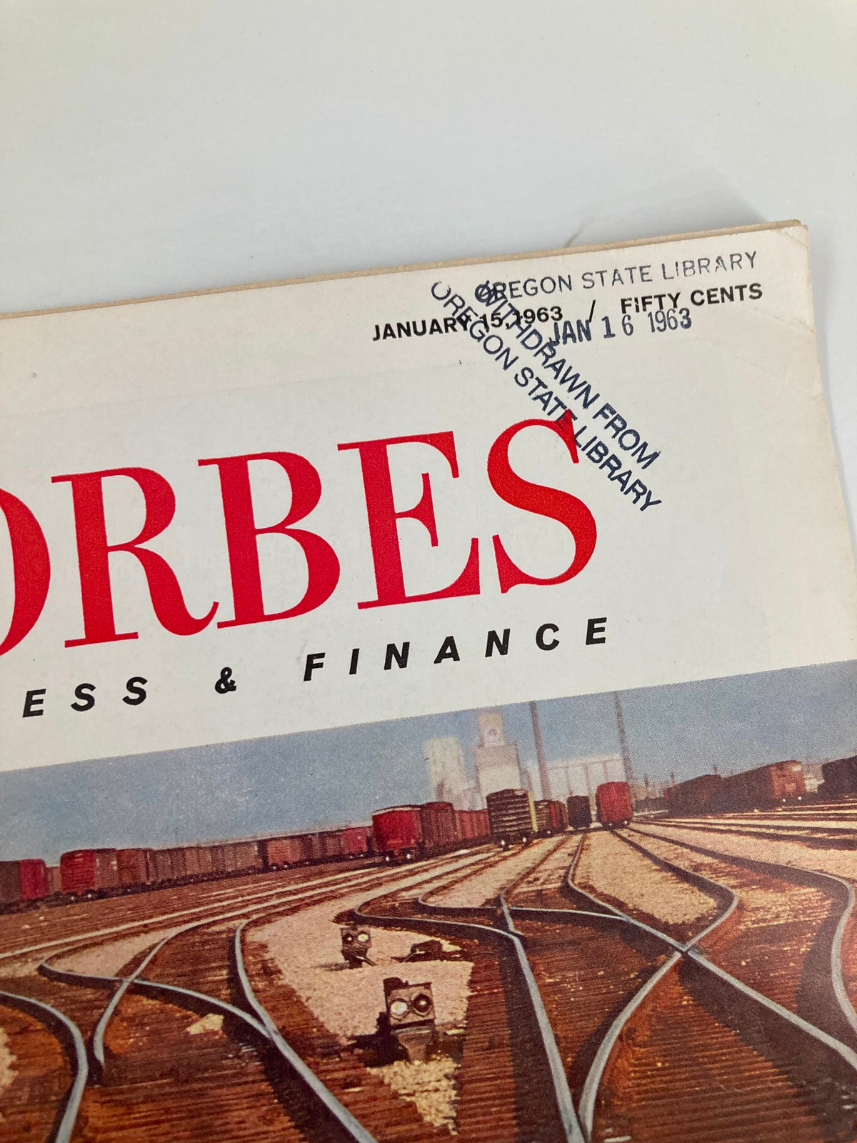 Close-up of the Forbes Magazine from January 15, 1963, displaying the magazine's title and librarian stamp, emphasizing its status as a collectible item.