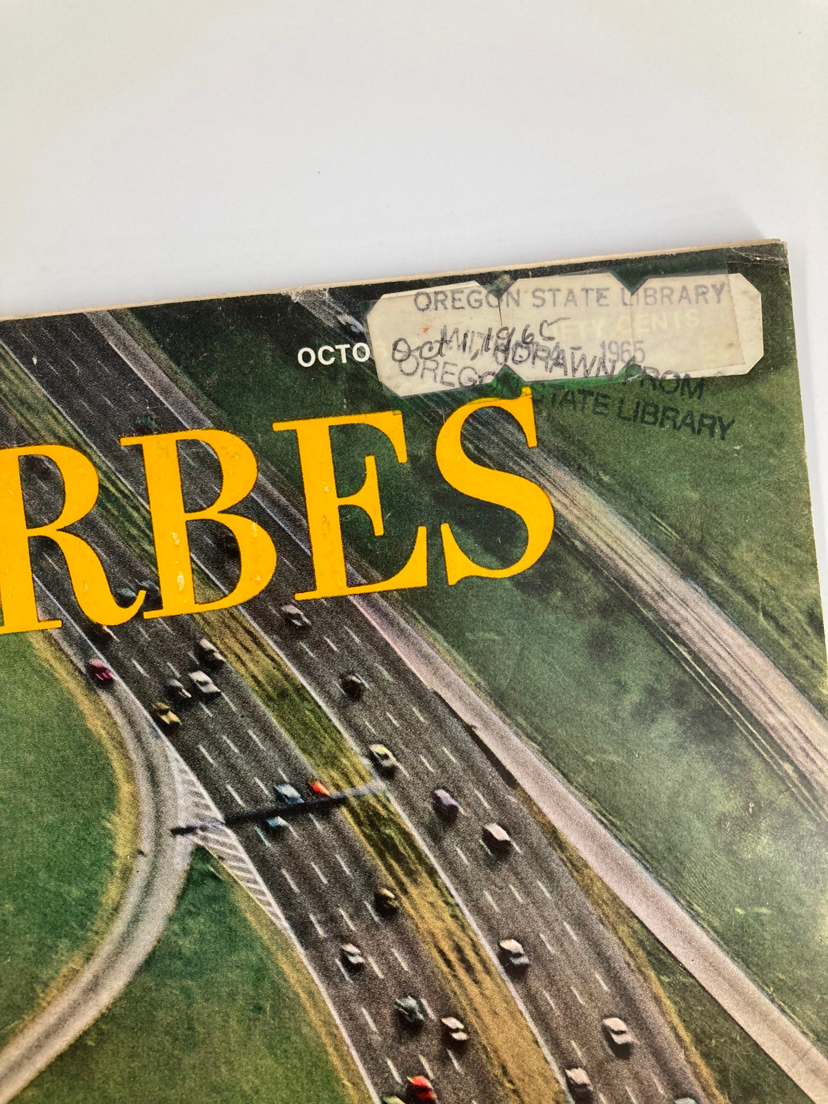 Close-up of the cover of VTG Forbes Magazine, October 1, 1965, displaying the title and a library label, emphasizing the vintage character of the publication.