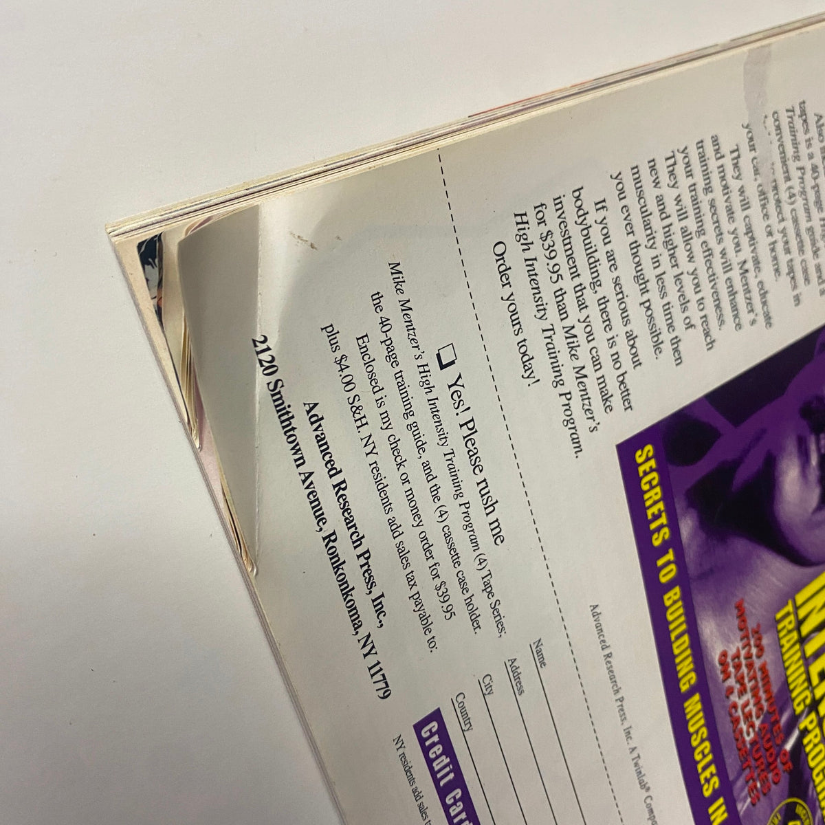 Detail of the back cover of Muscular Development Magazine December 1997 displaying an advertisement with minor wear.