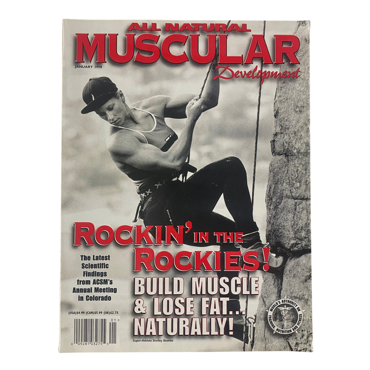 Cover of Muscular Development Magazine January 1998 featuring Shelley Beattie, American Gladiator and fitness icon, climbing a rock face, promoting natural bodybuilding and fitness insights.