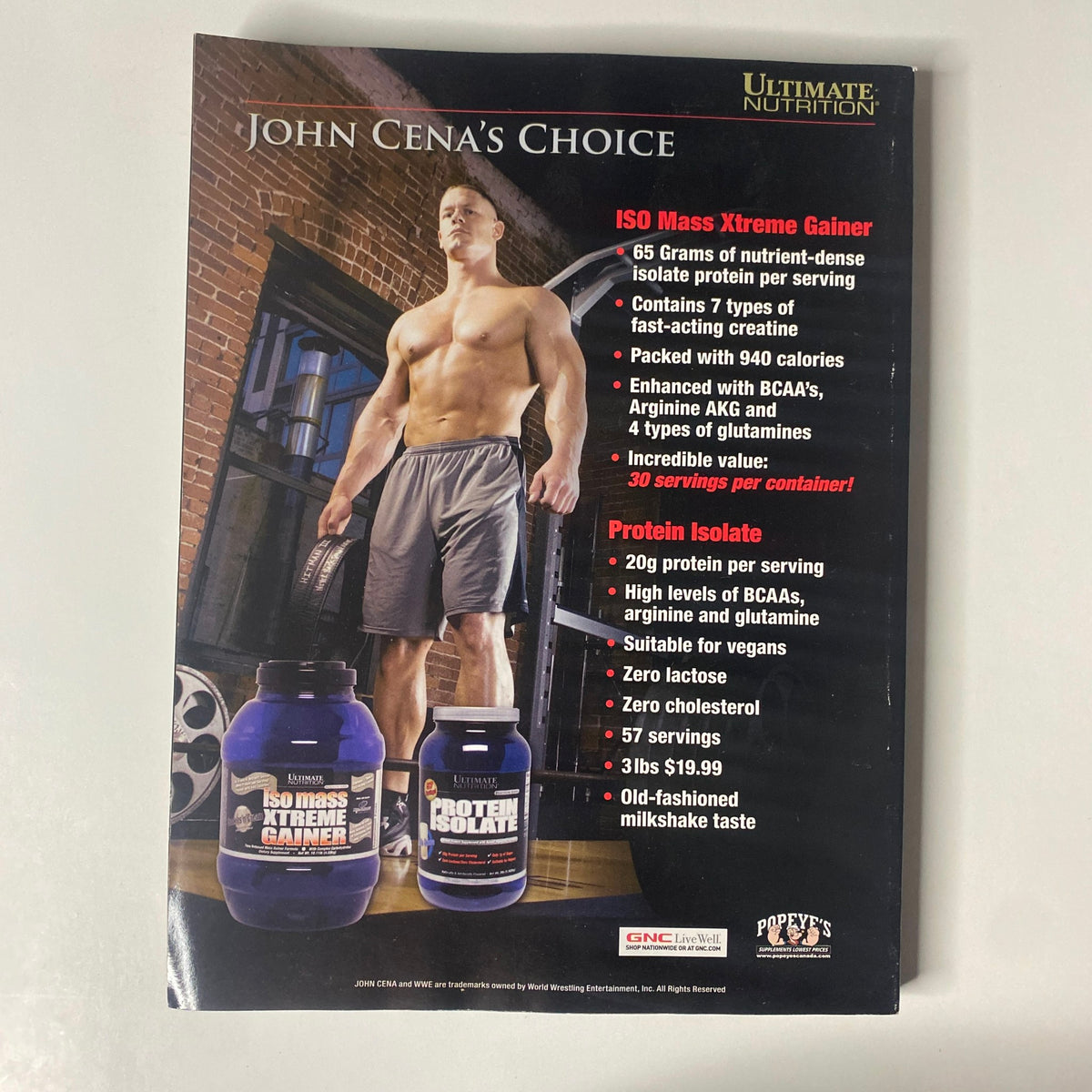 Advertisement for Ultimate Nutrition's ISO Mass Xtreme Gainer featured in Muscular Development Magazine November 2008, showcasing John Cena with product details and pricing.