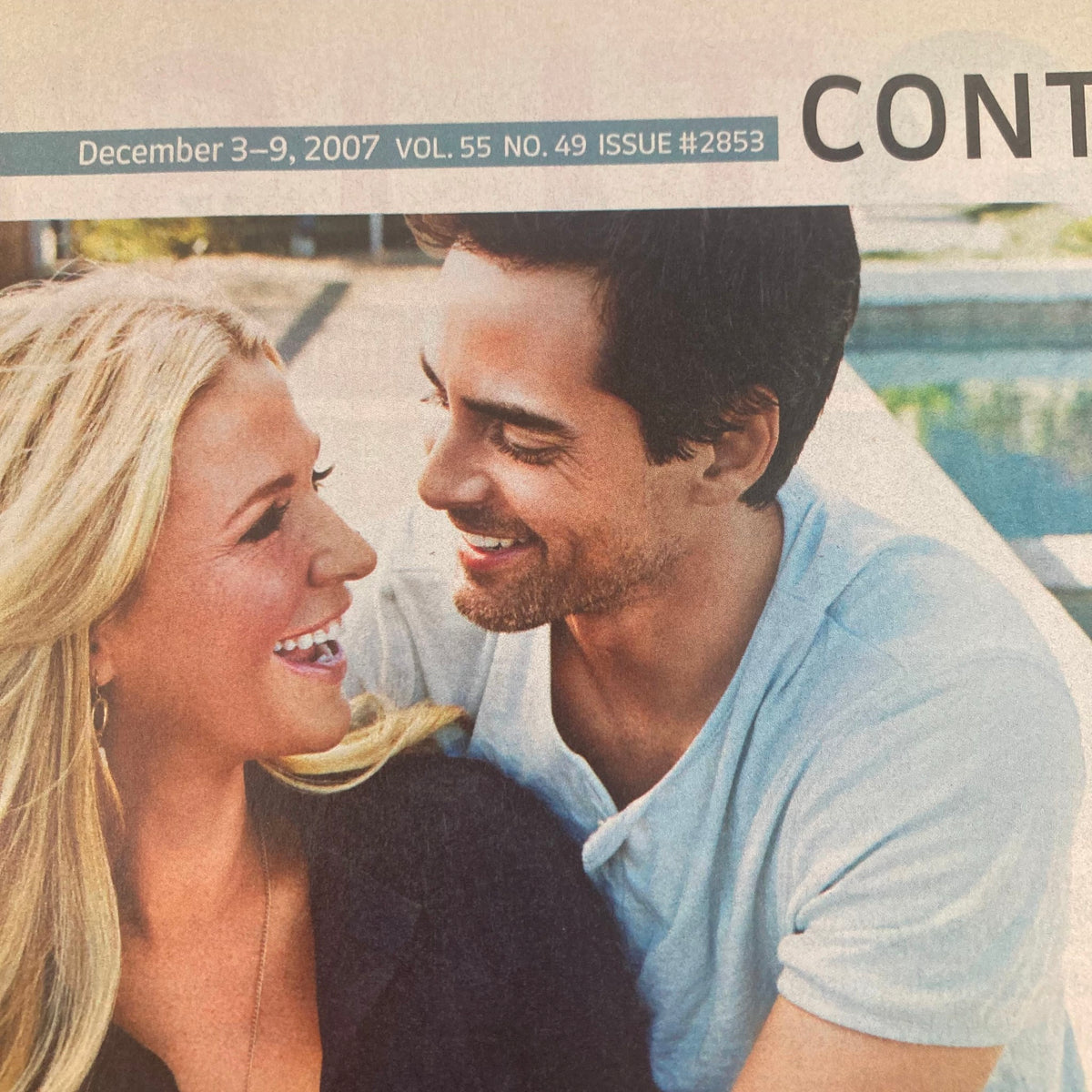 Close-up of Poppy Montgomery and a male co-star smiling at each other, from the TV Guide Magazine December 3 2007, Issue #2853, depicting warmth and connection in a vintage television feature.