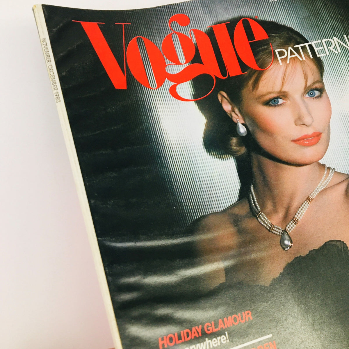 Detailed view of the cover of Vogue Patterns Magazine November 1980 highlighting Ninna Ricci Paneled Perfection with a model's striking features and style.