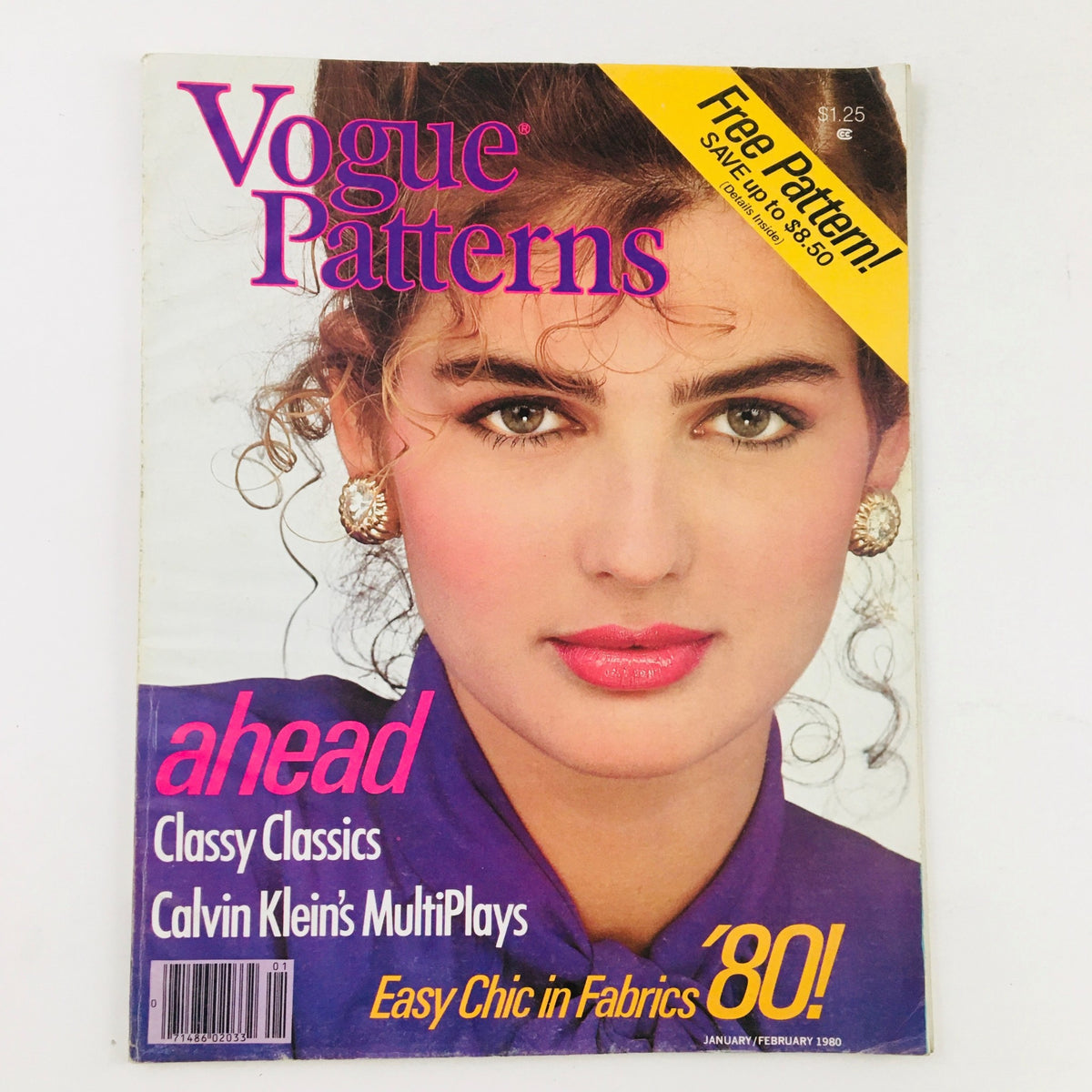 Cover of Vogue Patterns Magazine January 1980 featuring Yves Saint Laurent's Bow Blouse. The magazine highlights fashion design with a model showcasing stylish beauty, complemented by the text promoting 'Free Pattern!' and design ideas from the 1980s.