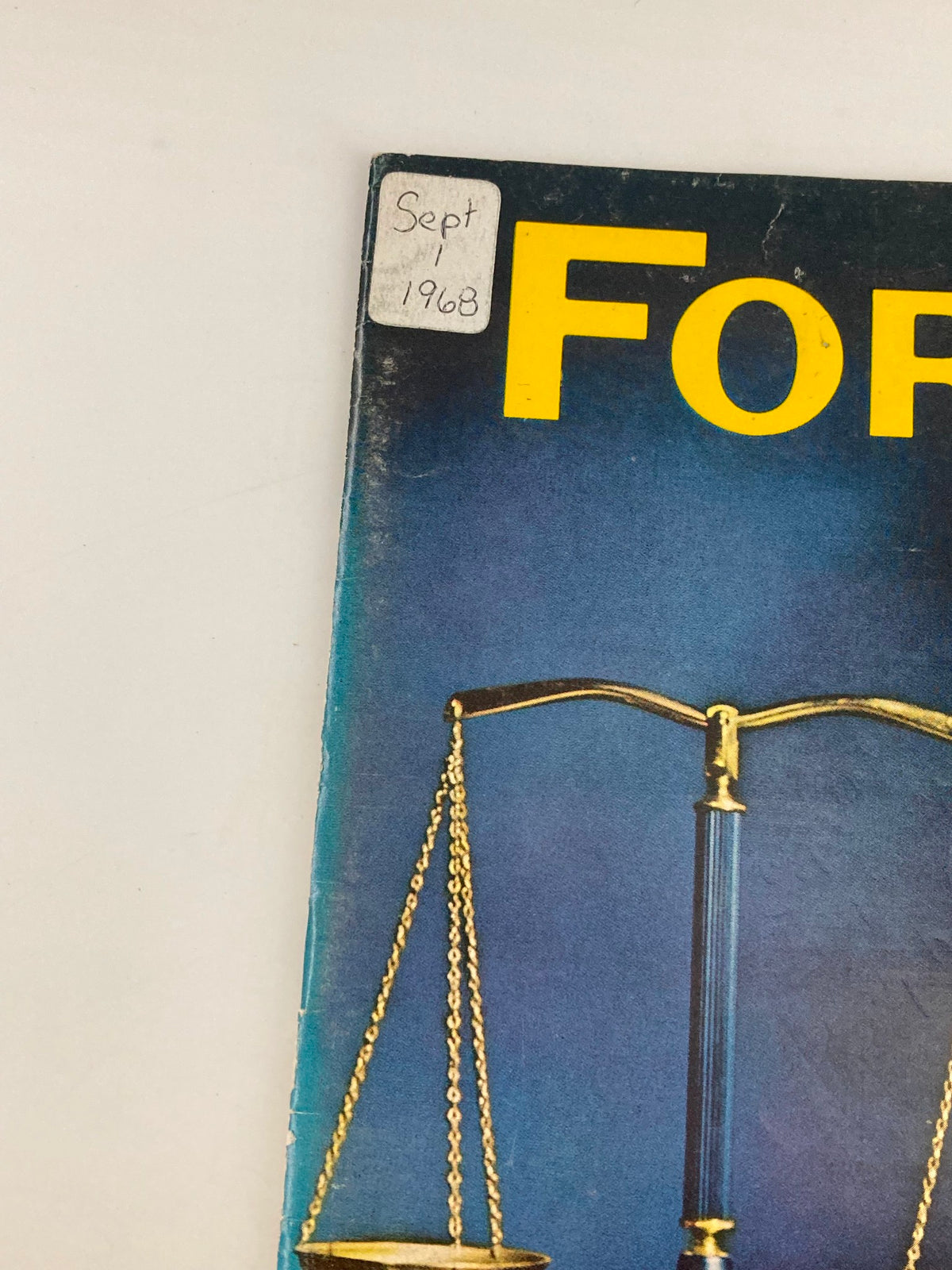 Cover detail of the vintage Forbes Magazine from September 1, 1968, featuring a handwritten note indicating the date and a scale symbolizing justice.