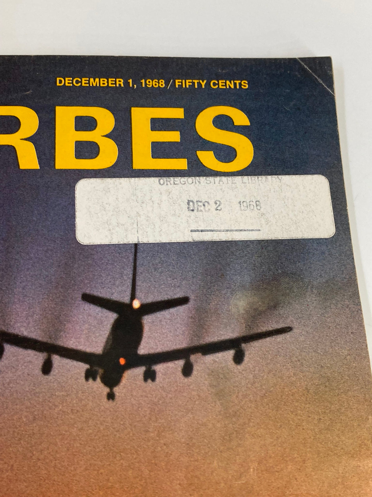 Close-up of the cover of VTG Forbes Magazine December 1, 1968, featuring a silhouette of an airplane and a library sticker.