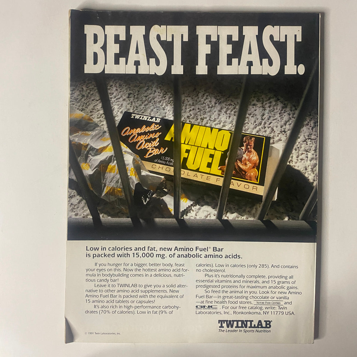 IronMan Magazine February 1992 Vol. 51 No. 2 advertisement for Amino Fuel Bar with promotion highlighting low calorie content and benefits for bodybuilding, showcasing a blend of fitness and nutrition products.