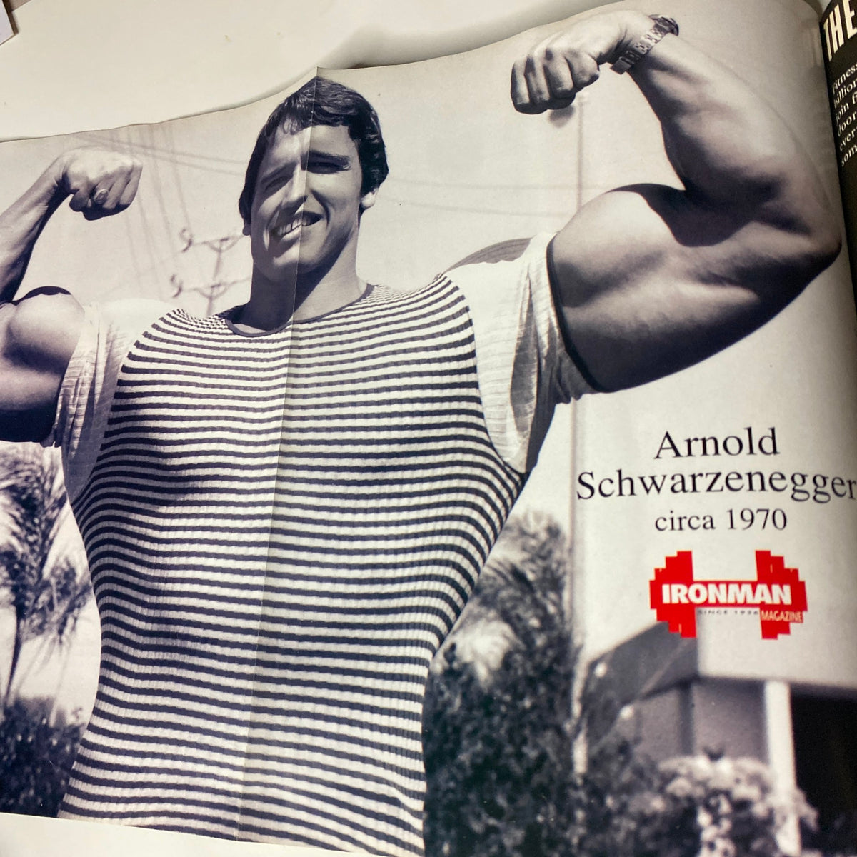 Vintage photo of Arnold Schwarzenegger circa 1970 featured in IronMan Magazine May 1994, showcasing his iconic physique and early bodybuilding career.